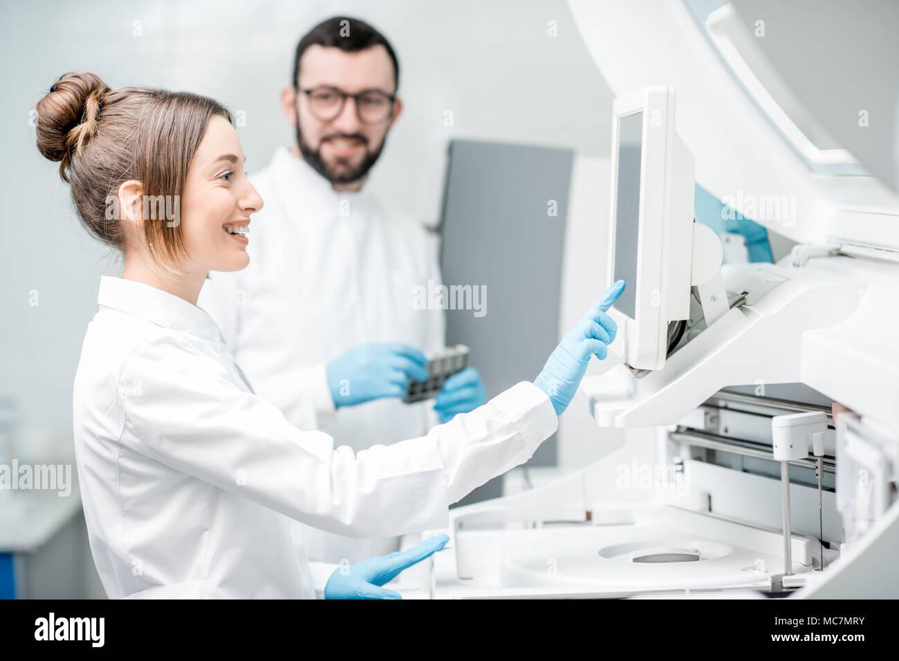 Doctor working biochemistry analyzer in hi-res stock photography and ...