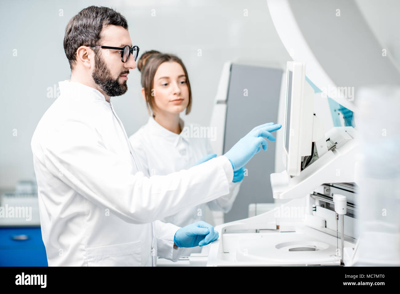 Doctor working biochemistry analyzer in hi-res stock photography and ...