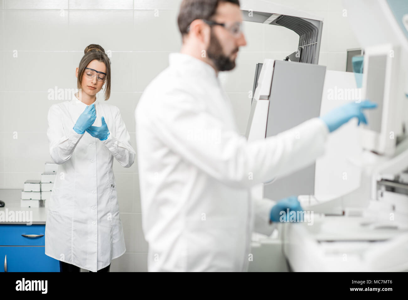 Doctor working biochemistry analyzer in hi-res stock photography and ...