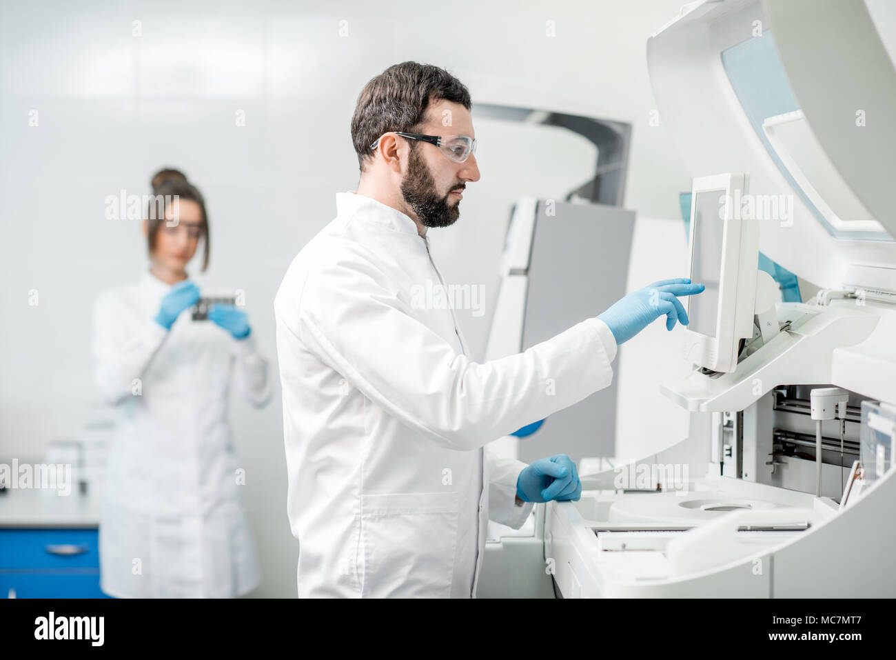 Doctor working biochemistry analyzer in hi-res stock photography and ...