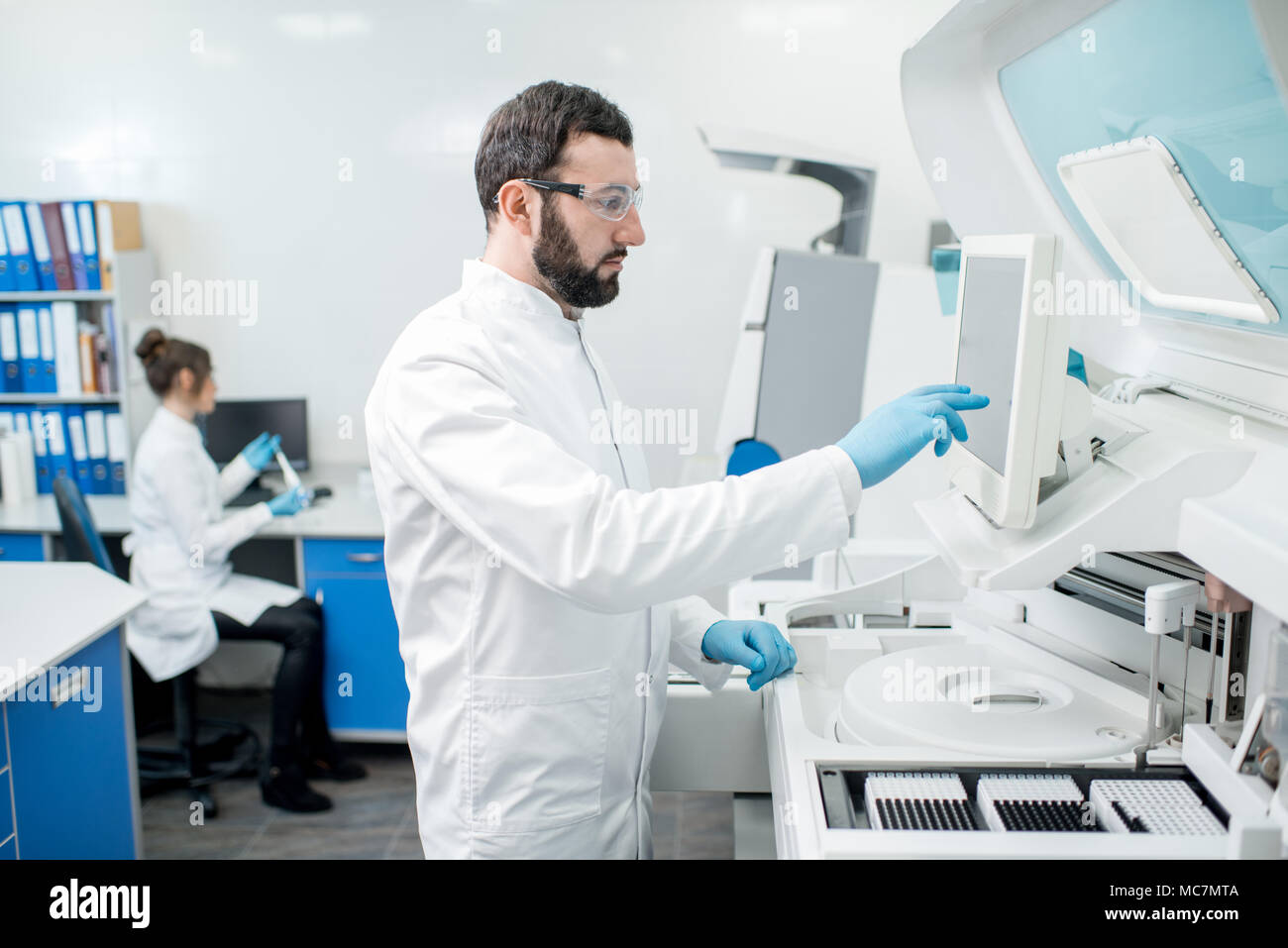 Doctor working biochemistry analyzer in hi-res stock photography and ...