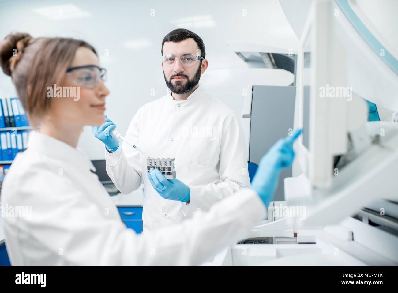 Doctor working biochemistry analyzer in hi-res stock photography and ...