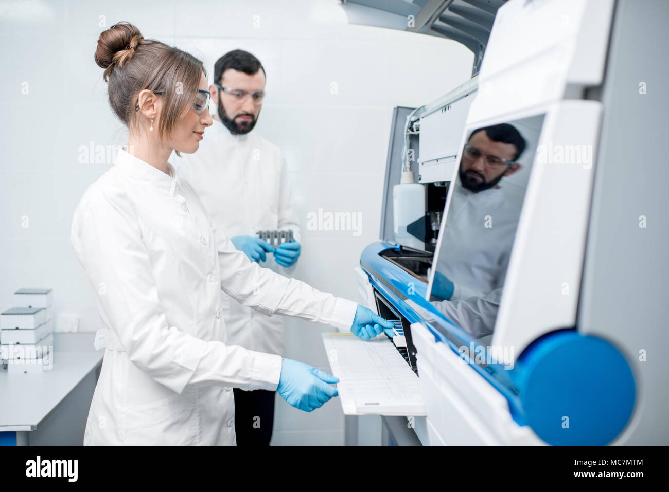 Doctor working biochemistry analyzer in hi-res stock photography and ...