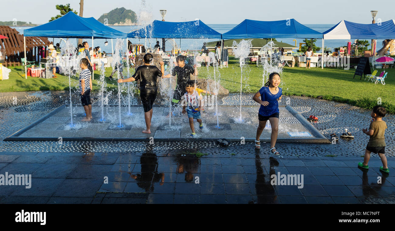 Seogwipo, Jeju Island, Korea - August 27 2017: Korean kids playing in a fountain Stock Photo