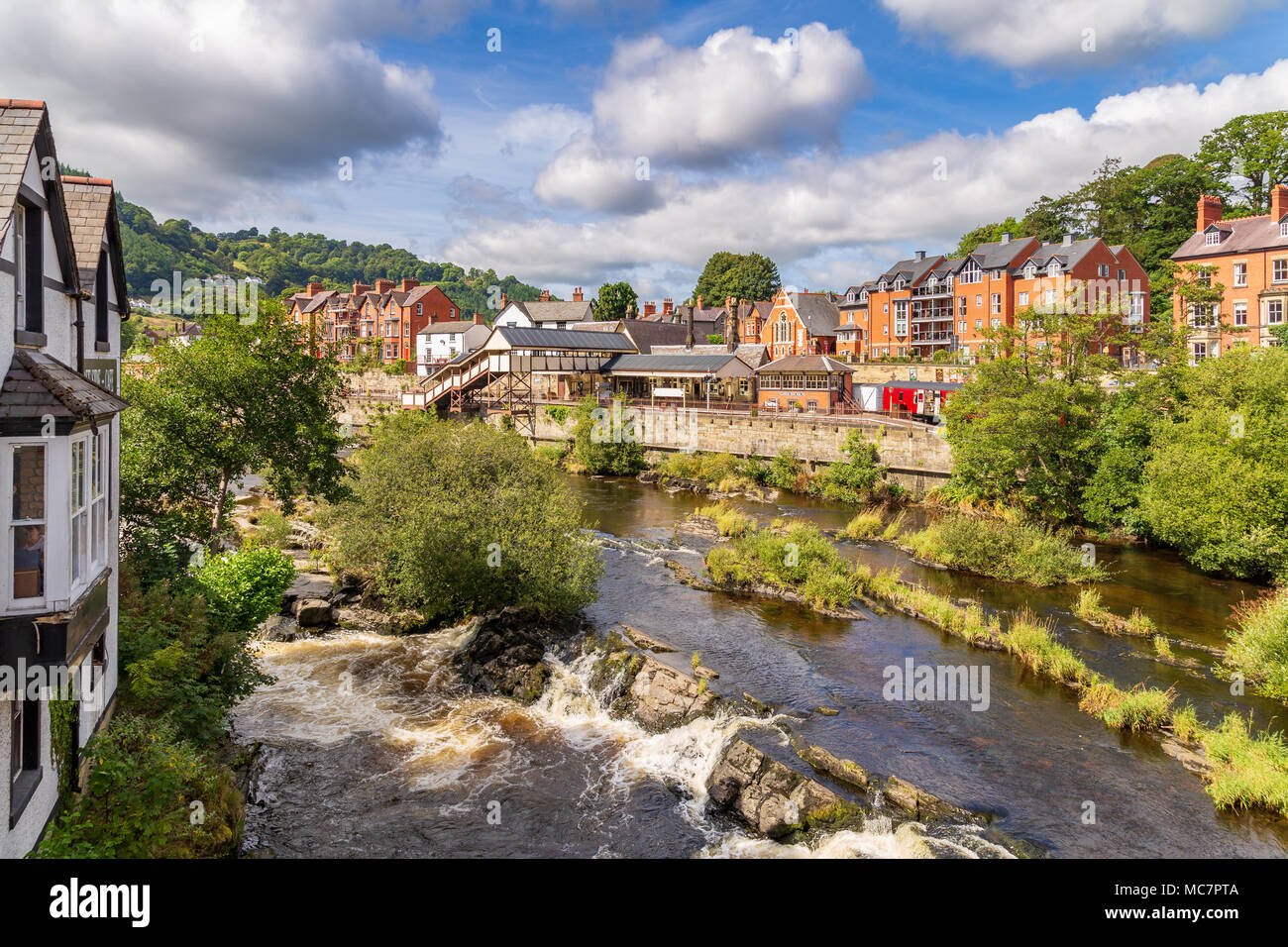 Llangollen, Denbighshire, Wales, UK - August 31, 2016: View from the Llangollen Bridge over the River Dee with the Railway Station in the background Stock Photo