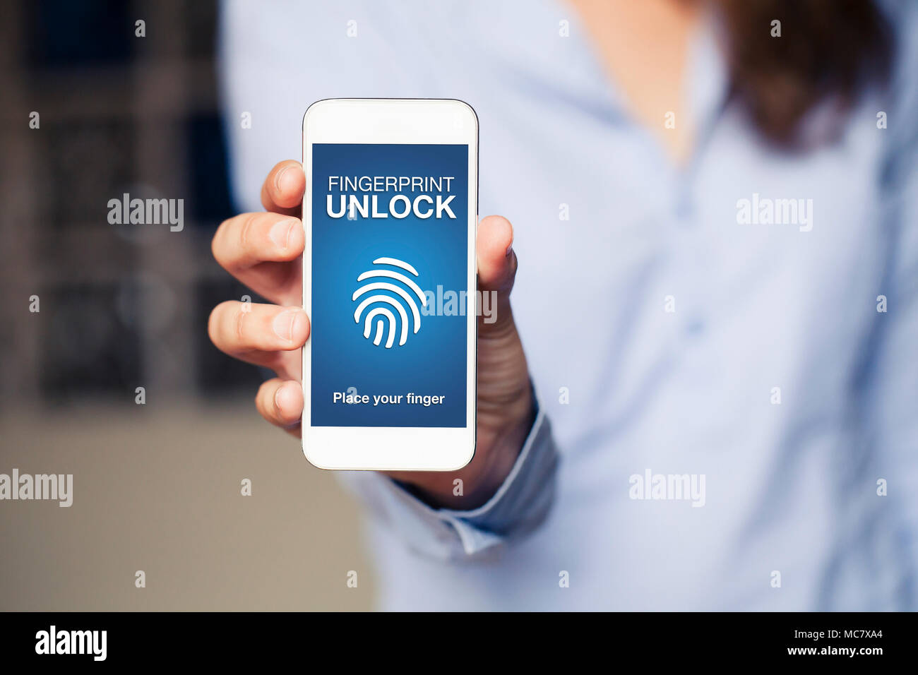 Fingerprint Unlock screen in a mobile phone. Woman holding phone in the