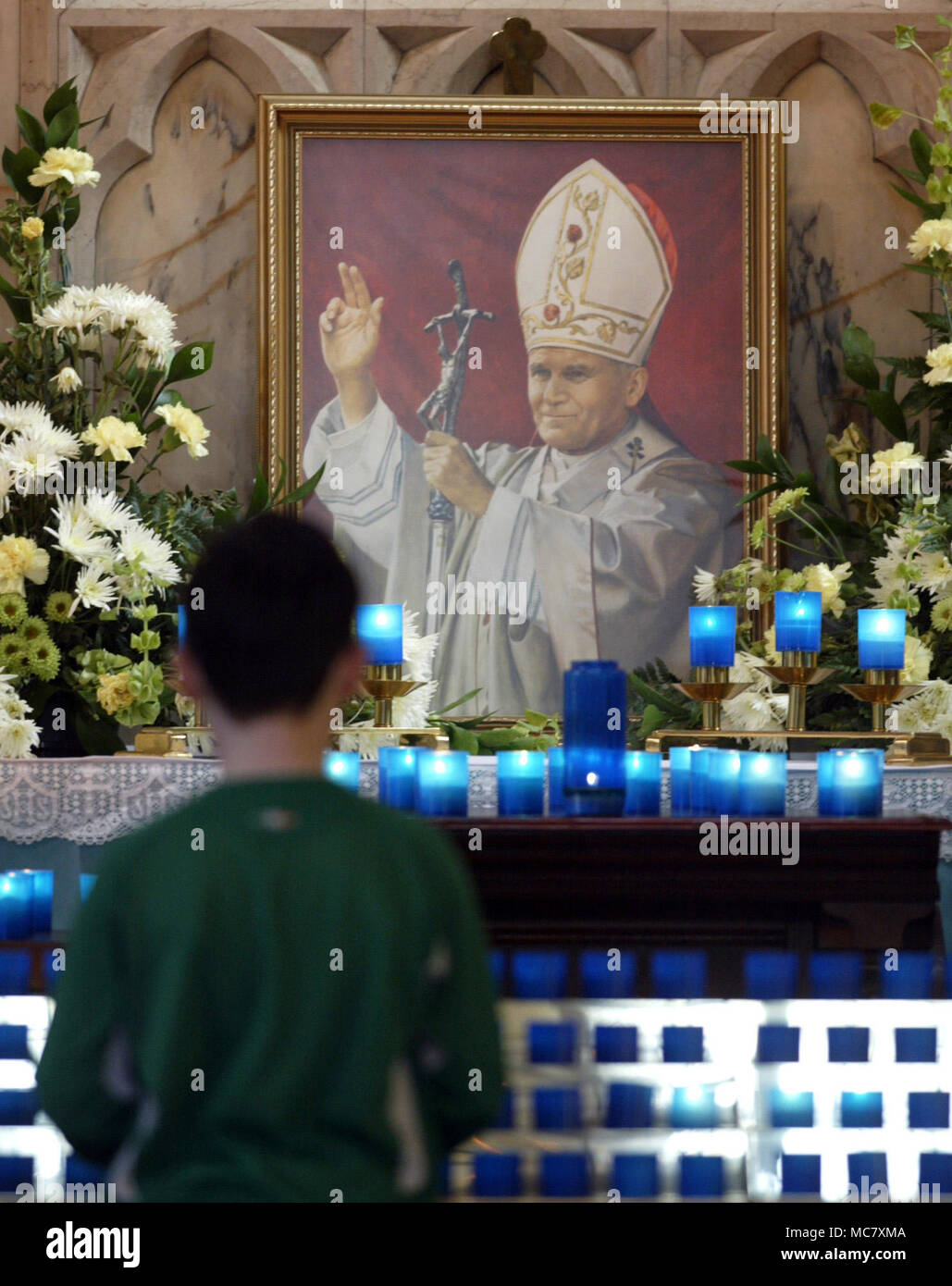 BELFAST, NORTHERN IRELAND - APRIL 2: A shrine with a painting of Pope John Paul II is seen at St. Paul's Chapel on the Falls Road April 1, 2005 in west Belfast, Northern Ireland. The Pope had been reported to be in a 'very grave' condition Stock Photo