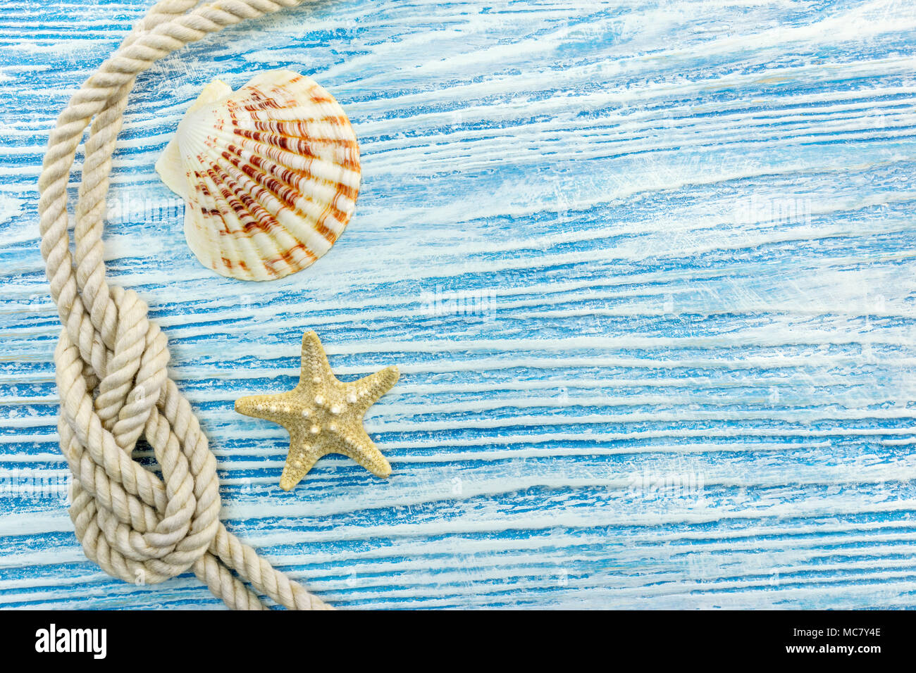 seashell, starfish, marine rope on blue wooden scratched boards. summer ...