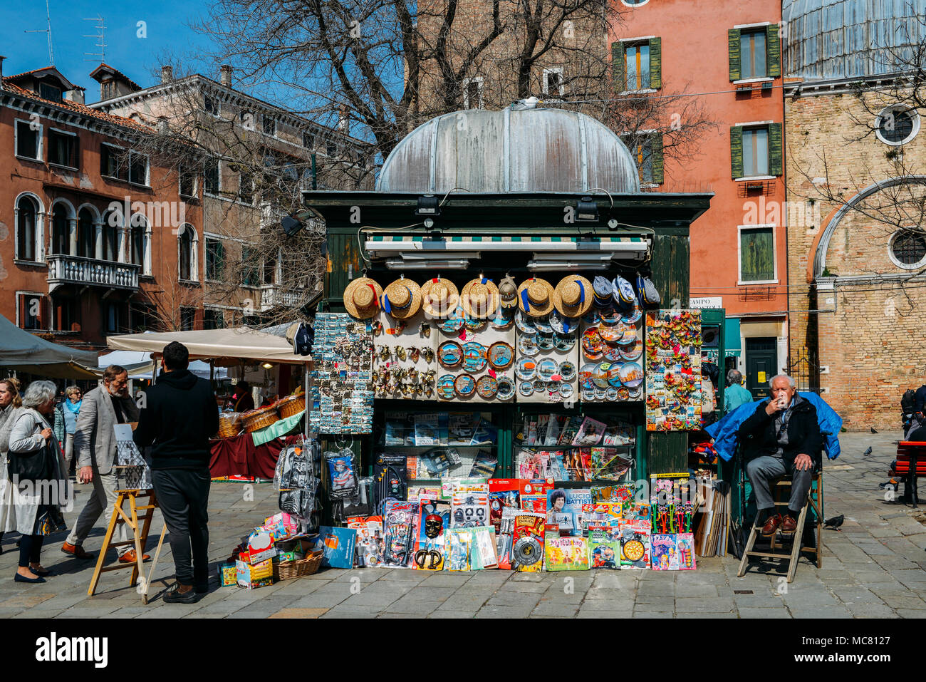 Venice, Italy - March 28, 2018: Pedestrians walk beside touristic market stalls Stock Photo