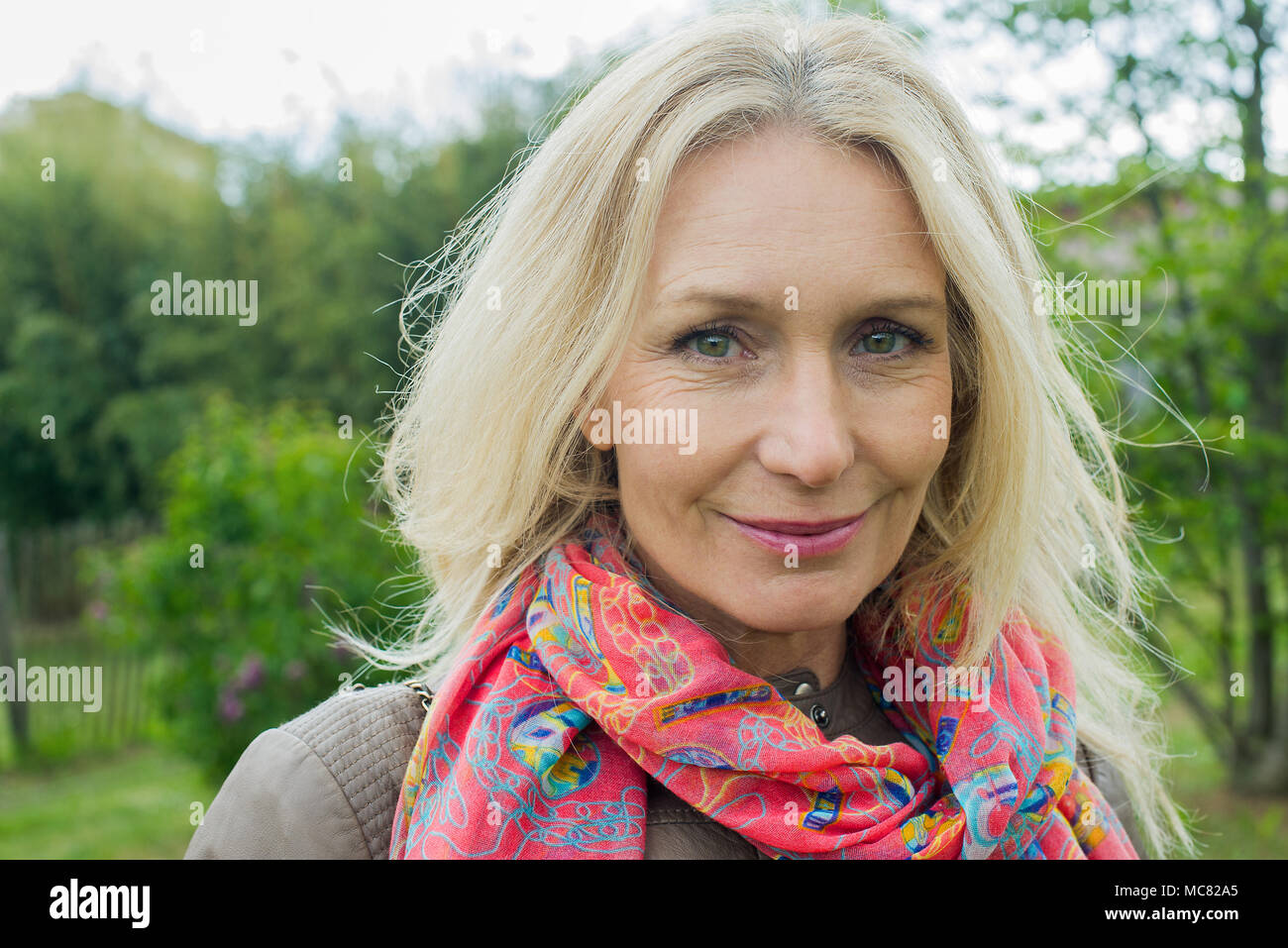 Mature woman smiling outdoors, portrait Stock Photo - Alamy