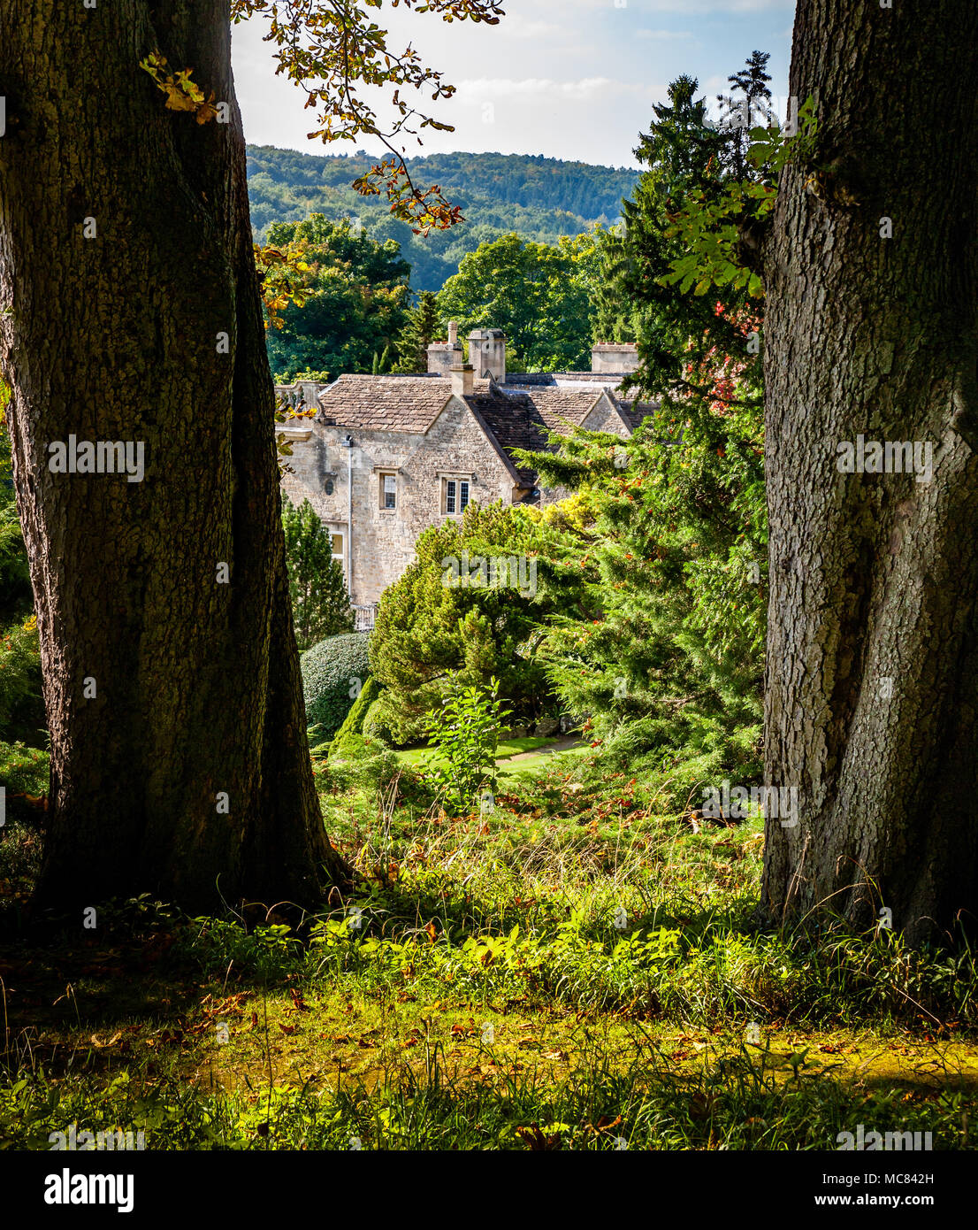 View from the upper paths of the Peto Garden over Iford Manor near Bath in Wiltshire UK Stock Photo