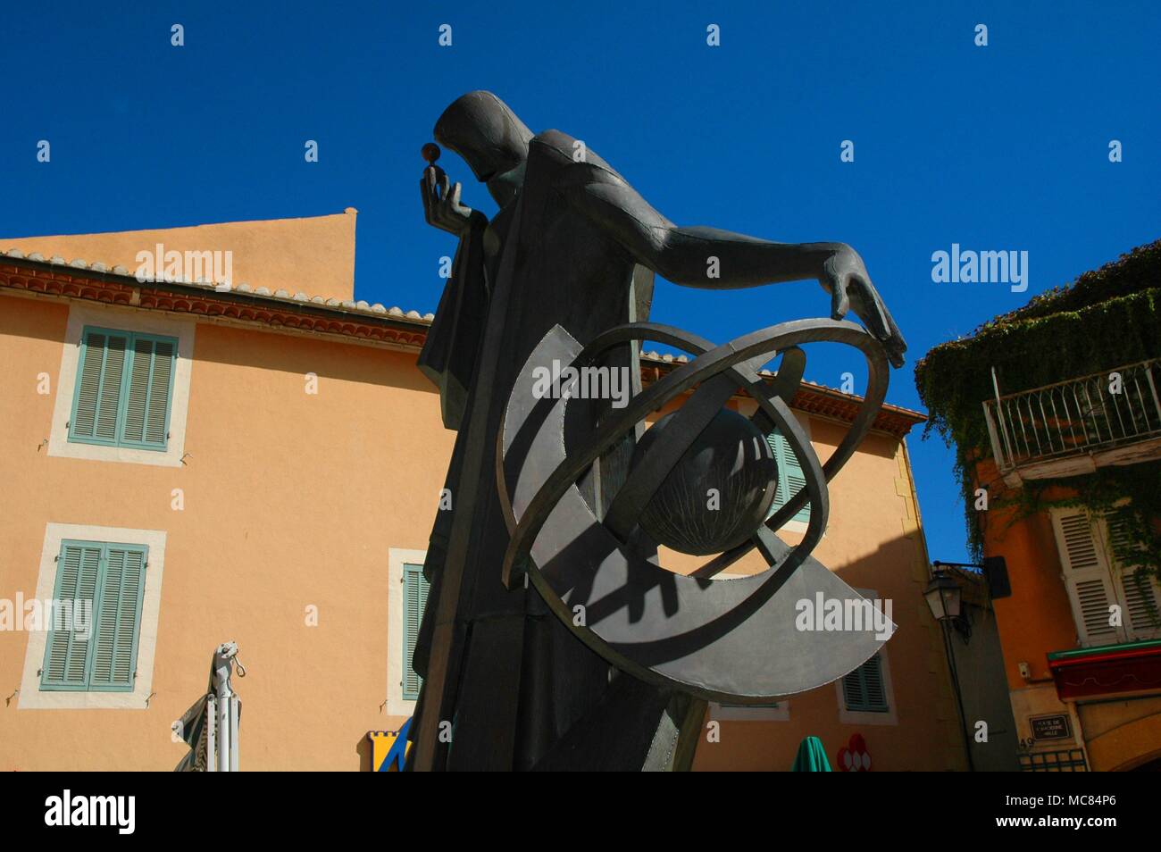 Sculpted in 1966, to celebrate the 400 anniversary of Nostradamus' death, the savant is depicted looking upon an hourglass. The statue is now in the old square within the walls of Salon, close to the house formerly owned by Nostradamus. Stock Photo