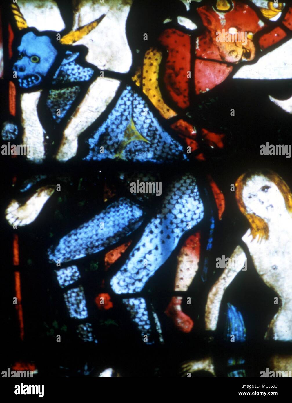 Demons in Hell - torturing the souls of the damned. From the stained glass in the west window of St. Mary's, Fairford Parish Church c.1490 Stock Photo