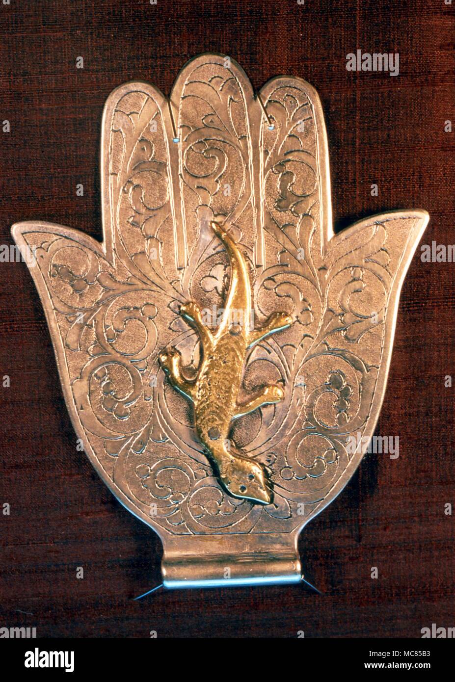 Khamsa, or Hand of Fatima. Unusual khamsa, the hand which turns aside the evil eye, with lizard in place of the magic eye. Arabic, 19th century, from Tariq Rajab Museum. Stock Photo