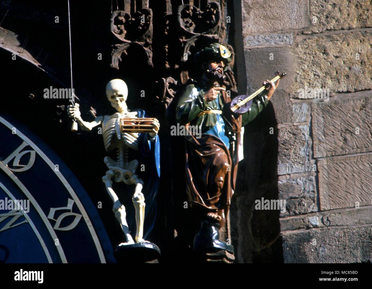 Death, in the form of a skeleton, pulls the rope which releases the processions of the Apostles, on the horlogium in the Town Hall Square, Prague. Stock Photo