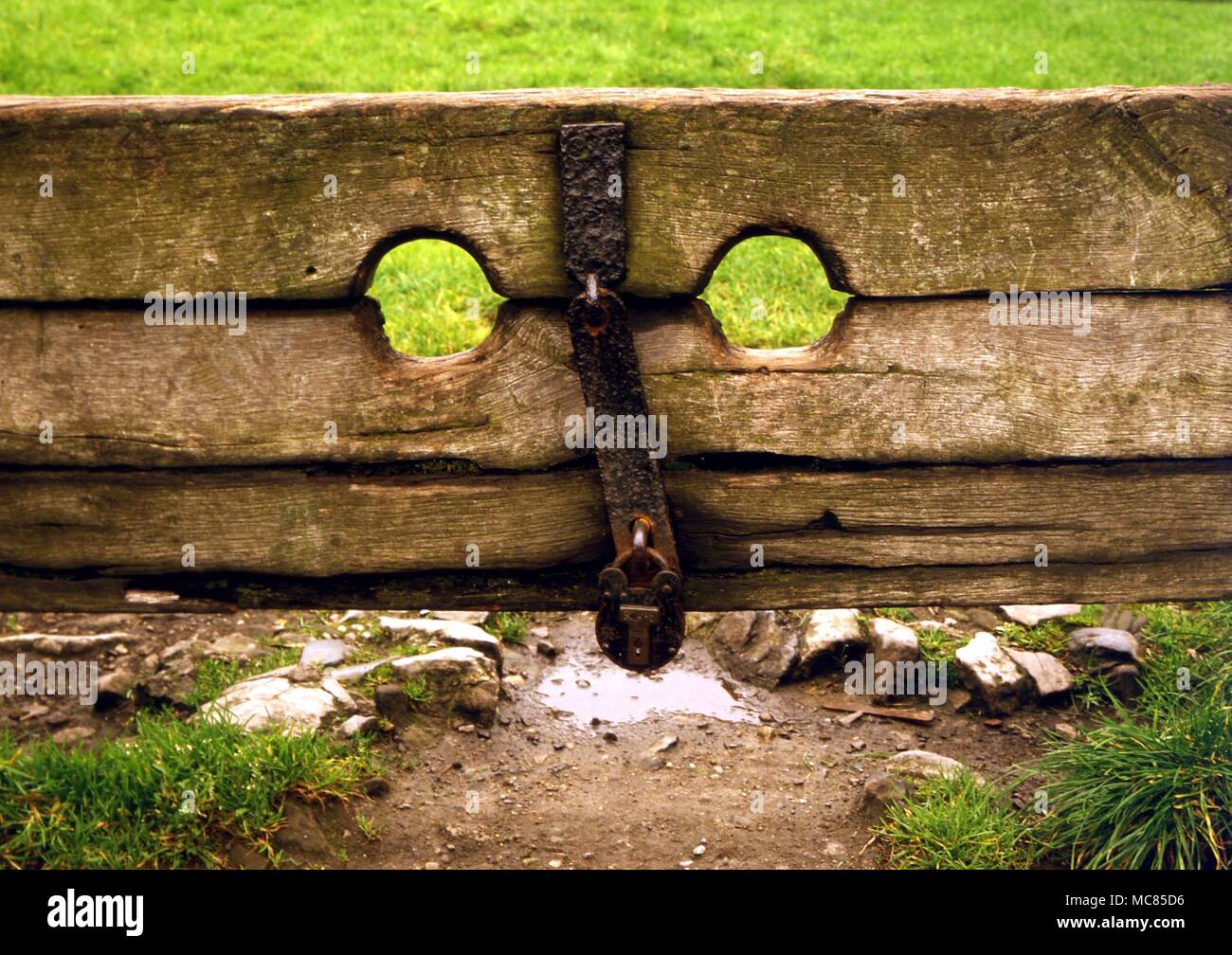 Stocks in the plague village of Eyam. During the 1665 plague, the village elected to isolate itself, rather than be responsible for spreading the disease further. The original village stocks are still on public view. Stock Photo