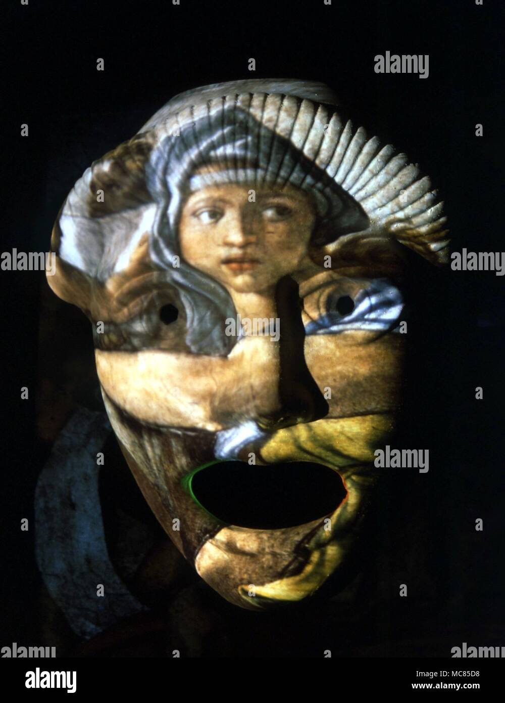 A symbol of the ancient Greek initiation mysteries - an image of the Oracle at Delphi, projected on to a mask - then regarded as symbol of the earthly persona, or personality, which was a tool to initiation. Stock Photo