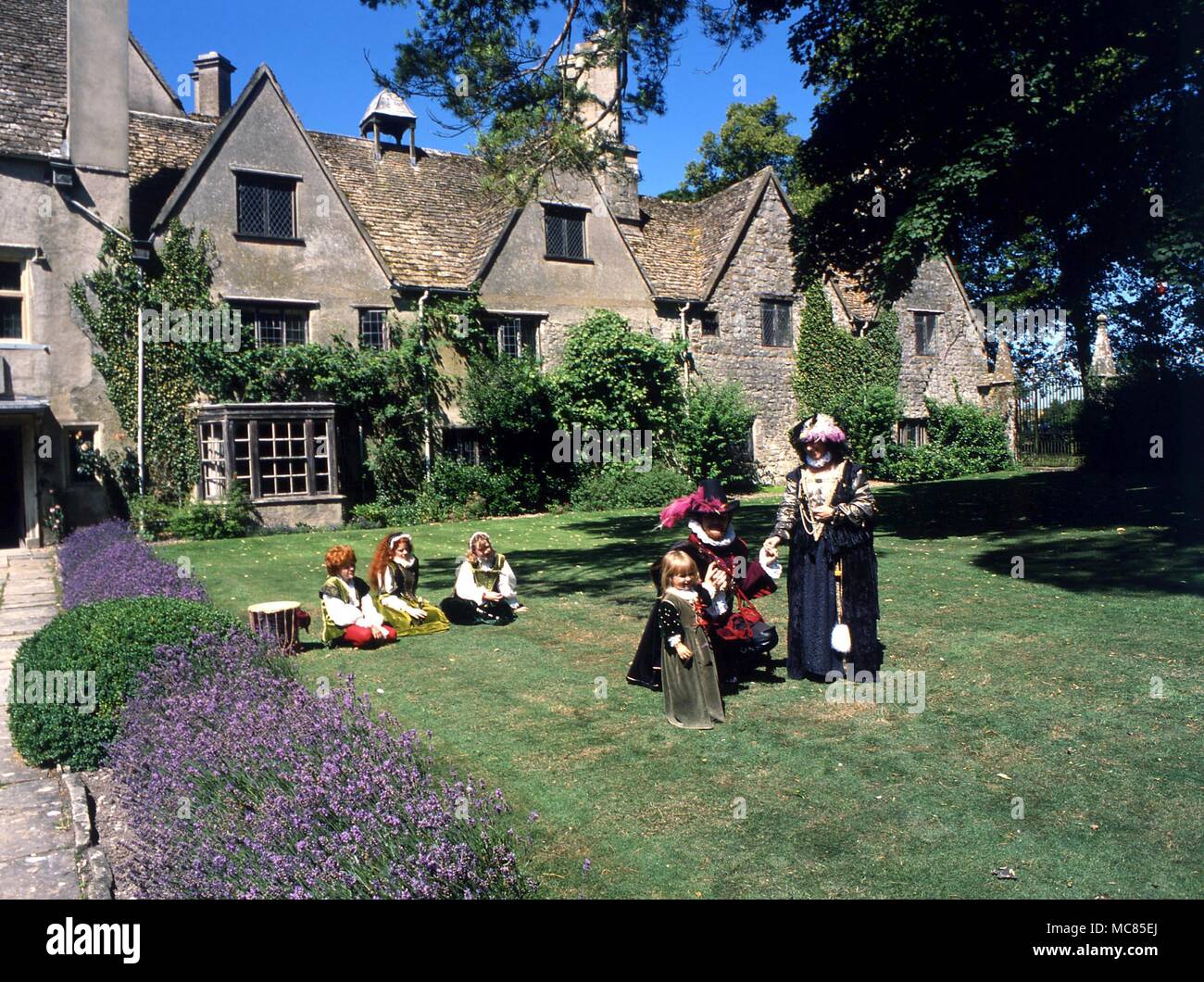 Theatre group, dressed in Elizabethan costumes, on the lawn of Avebury