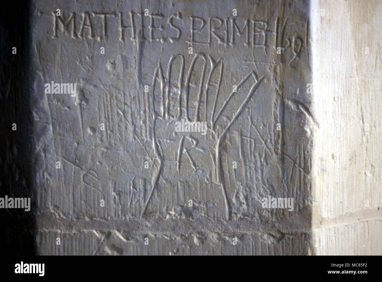 Late mediaeval graffiti of a sacred hand, scratched into the stonework of the parish church at Thriplow, perhaps by Matthies Prime, in 1691. Because the hand is the source of creative activity, it was regarded in former times as a symbol of power. Stock Photo