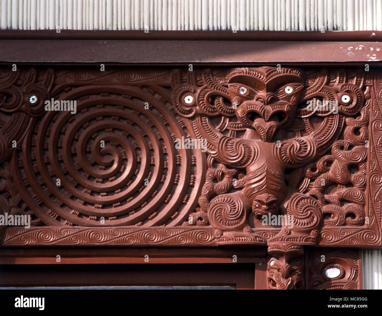 Spiral - Maori. double spiral, admist the traditional ornate Maori carving, on a meeting house at Whatkarewasrew, Rotorua, New Zealand. Stock Photo