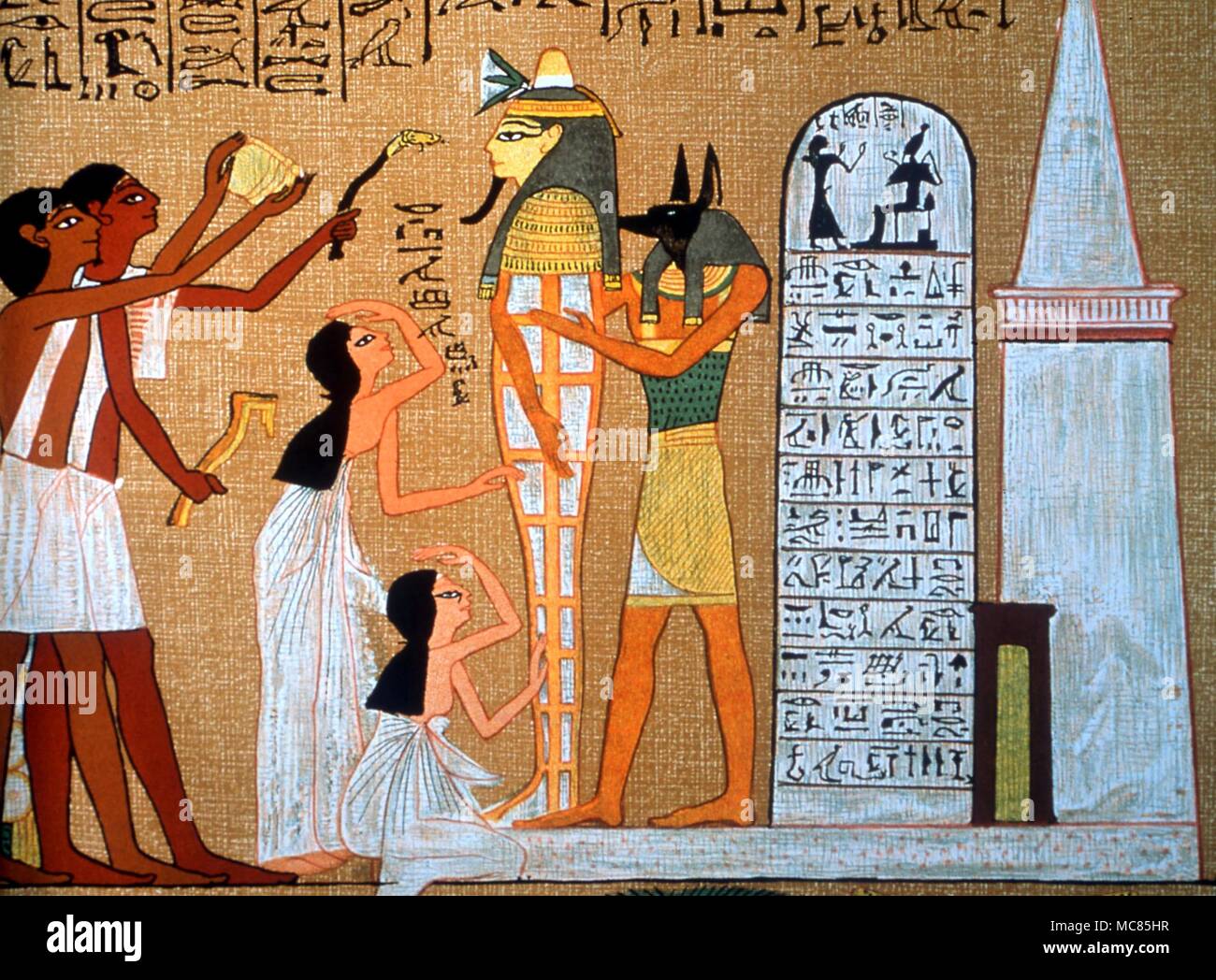 The jackal-headed god, Anubis, with the mummy of Osiris, during the rite of the opening of the mouth. Detail from the so-called 'Egyptian Book of the Dead'. Budge's translation. Stock Photo