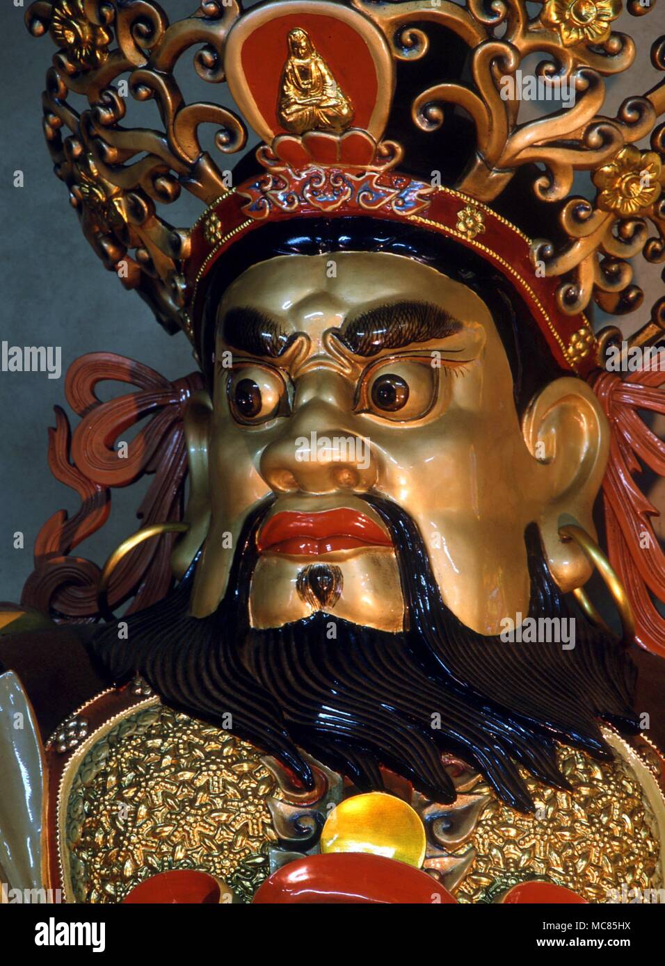 Face of the gigantic Guardian of the East who carries a magical sword ('blue cloud') on which are engraved the sigils for the elements. In the Po Lin Monastery, Lantau. Stock Photo