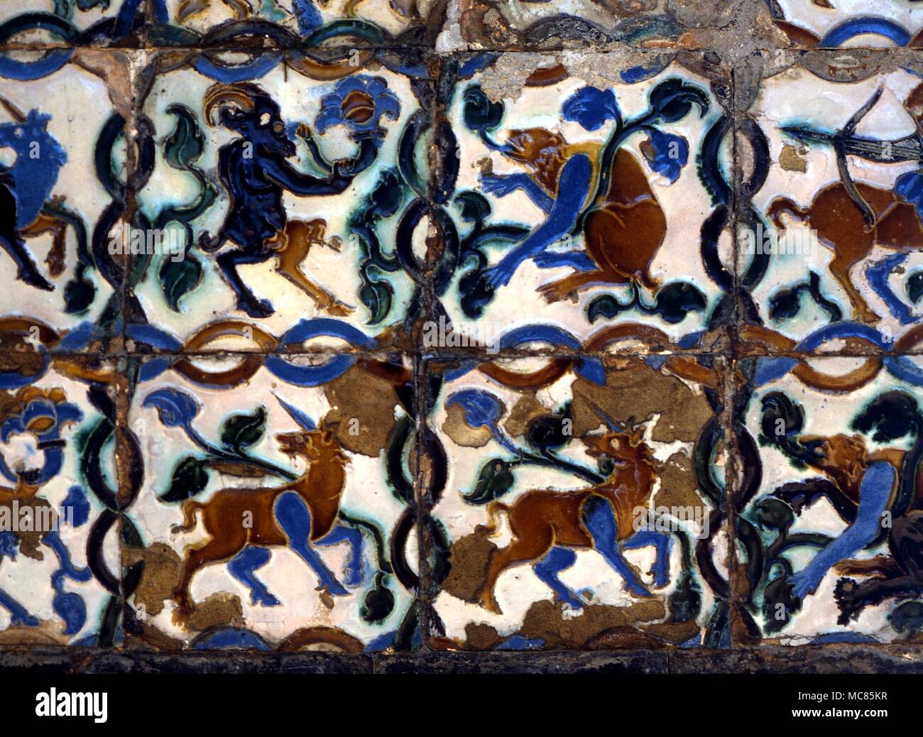 Emblematic figures of two unicorns, and two satyr-like goats. Tiles on the walls of the garden of the Alcazar, Seville, Spain. Stock Photo