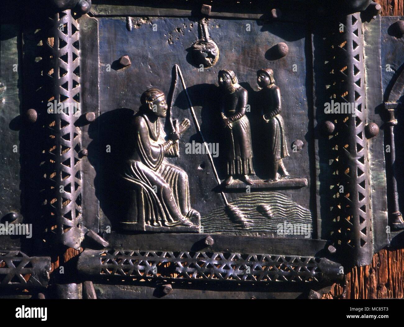 Christian San Zeno fishing - incident from the story of his life. 12th century (?) panel on the bronze doors of San Zeno, in Verona Stock Photo