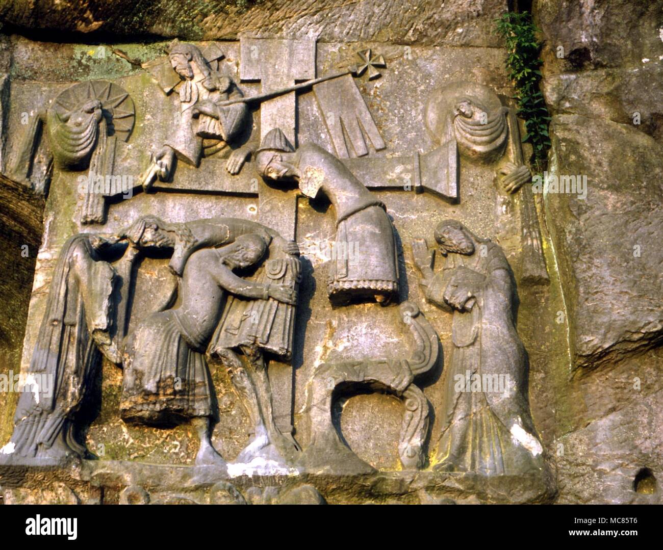 Christian The deep relief showing the Descent from the Cross, with the Irmensul. From the mediaeval carving on the living rock of the Externsteine stones, near Detmold Stock Photo