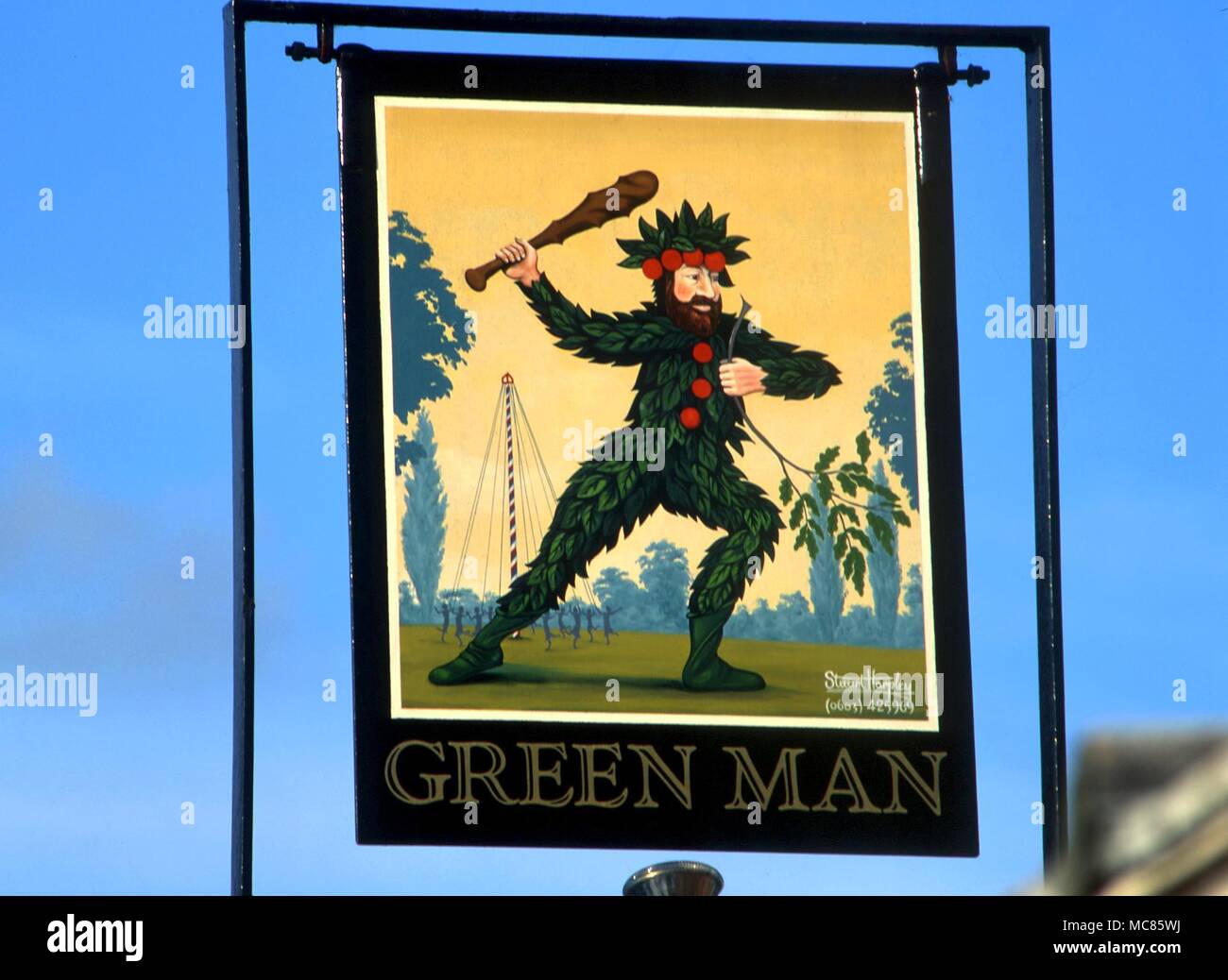 Green Man image on pub sign of the Green Man public house on the A148 to the east of Fakenham, Norfolk. This Green Man combines elements from the Wild Man tradition Stock Photo