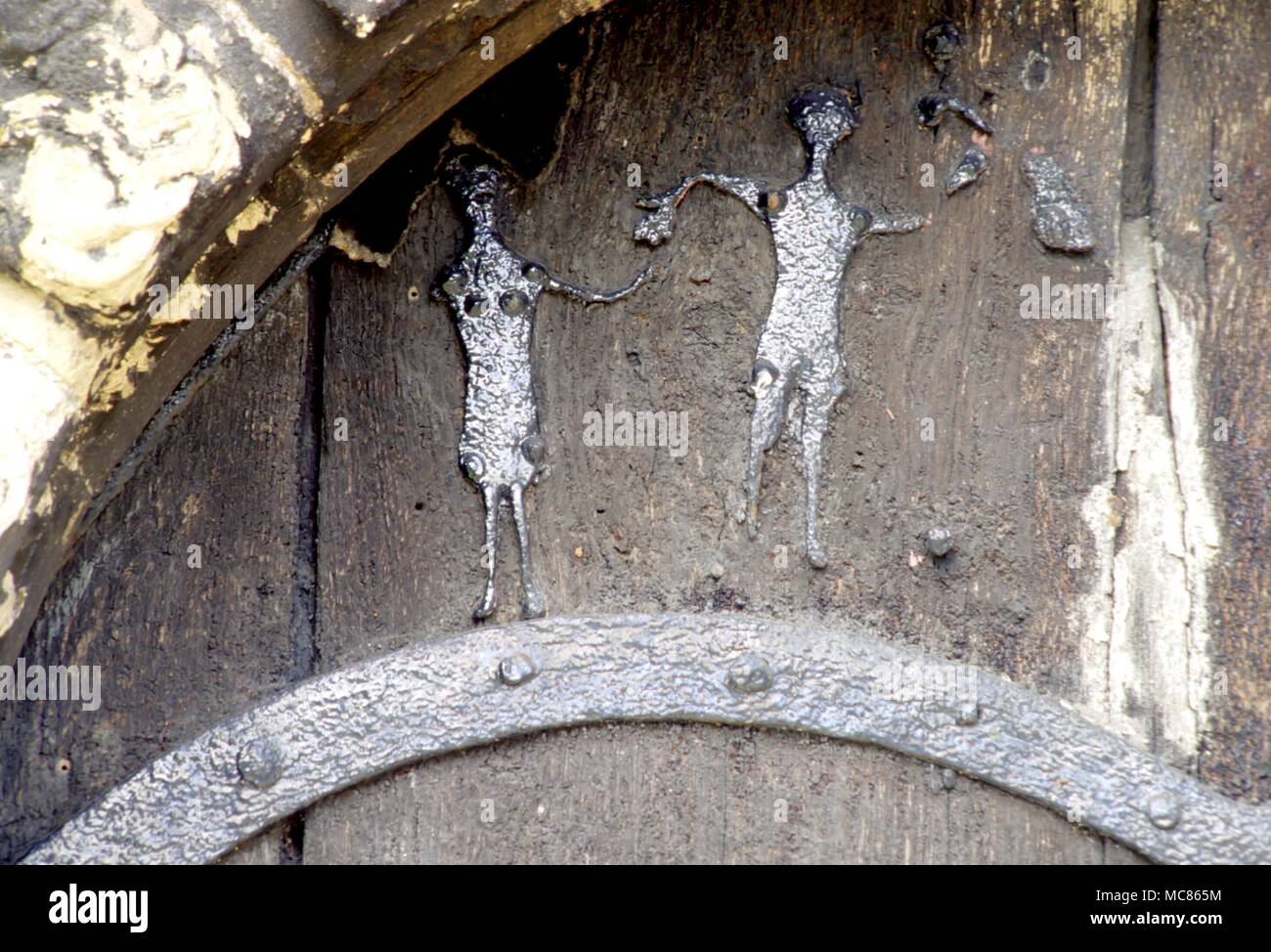 CHRISTIAN 'Adam and Eve' in the metal scrollwork on the mediaeval doorway of the parish church at Stillingfleet. Probably 10th century, but said by some to have been of Viking origin Stock Photo