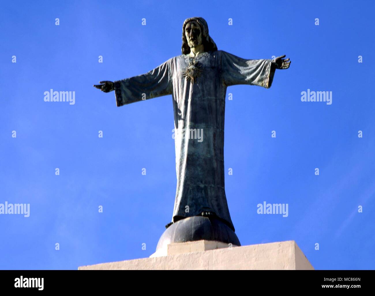 CHRISTIAN Christ blessing the world. Statue on a plinth on the top of El Toro, near the monastery in the centre of Minorca Stock Photo