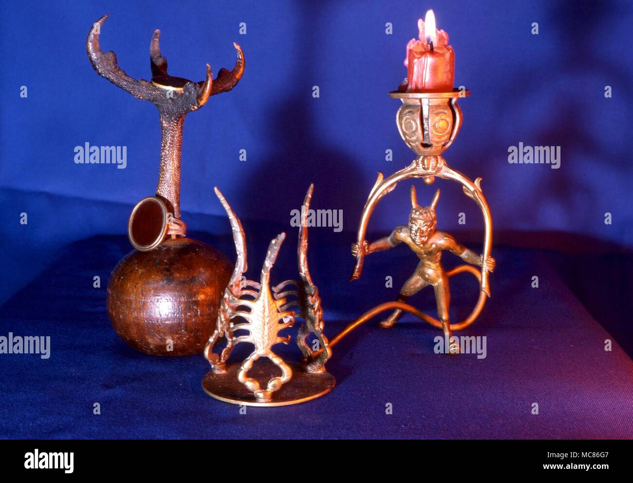 Exotic candle holders from the witchcraft tradition - bird's claw, gnostic demon head and demonic pan figure Stock Photo