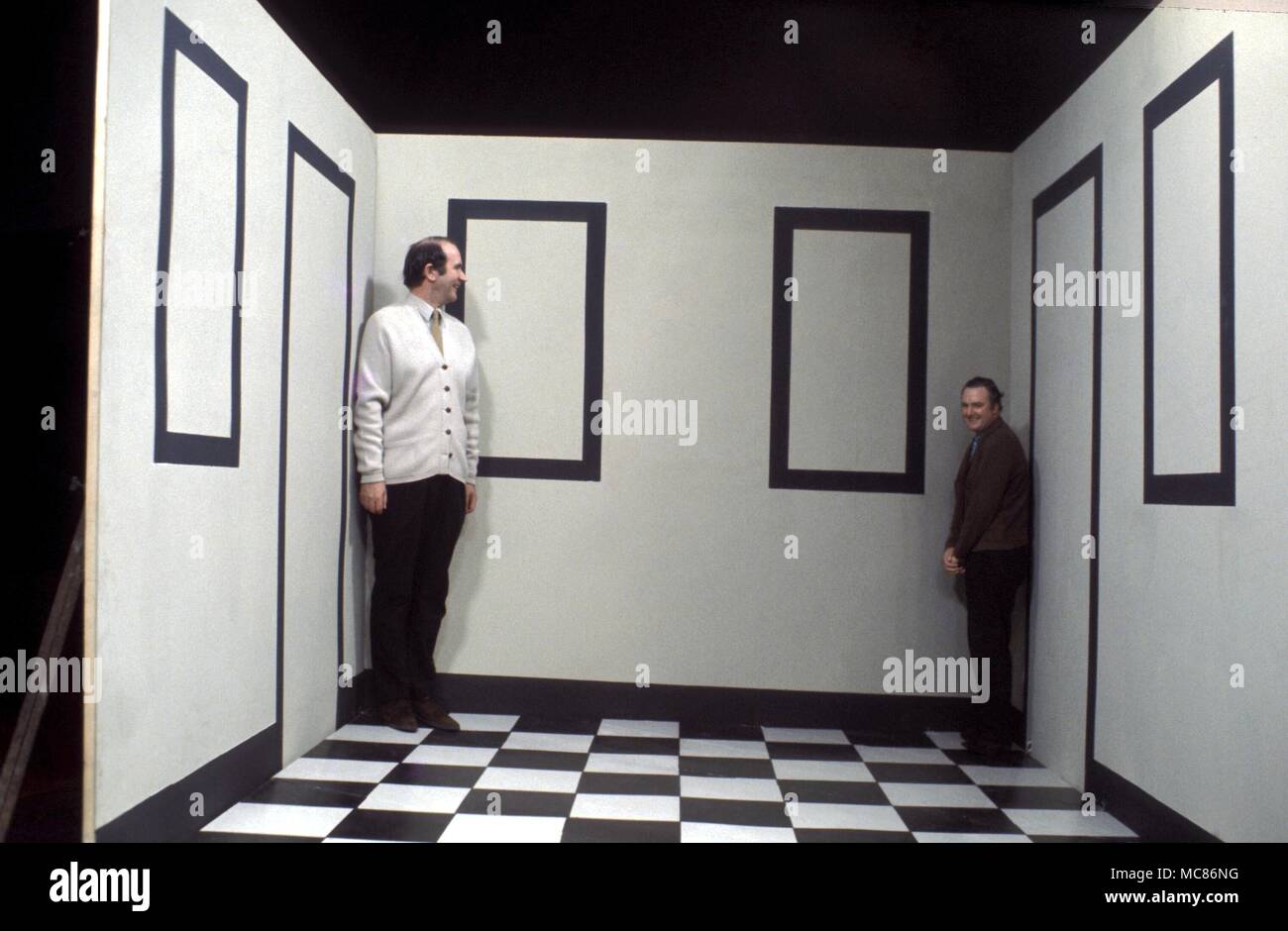 SCIENTIFIC CURIOSITIES Two men standing in an Ames Room, which gives an optical illusion that changes the relative sizes of the men. A further image shows reversal of sizes Stock Photo