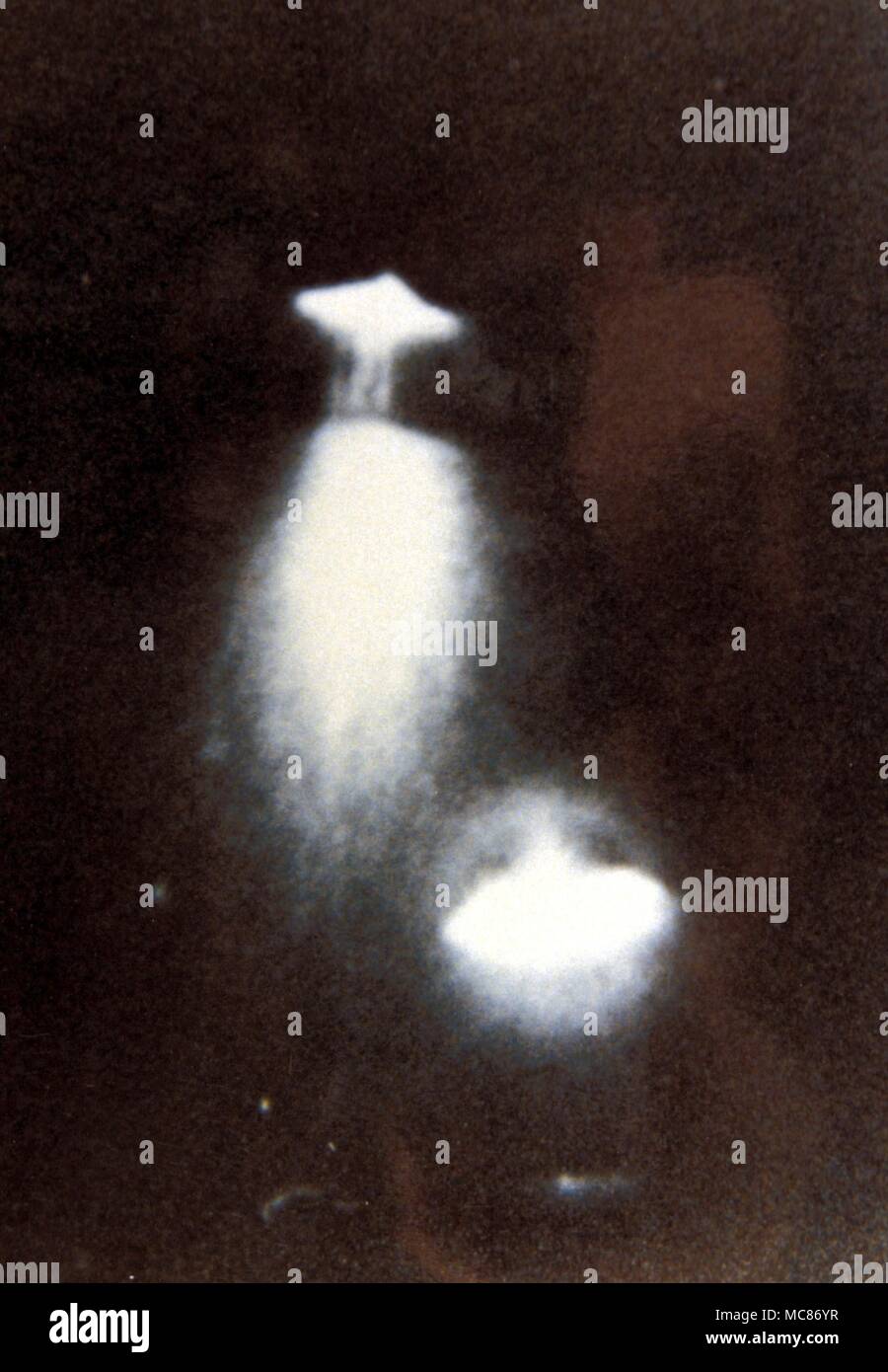 UFOs photographed through a four-inch telescope on 11th July 1971 at night time over Dayton, Ohio. From the Wendelle Stevens Archive. Stock Photo