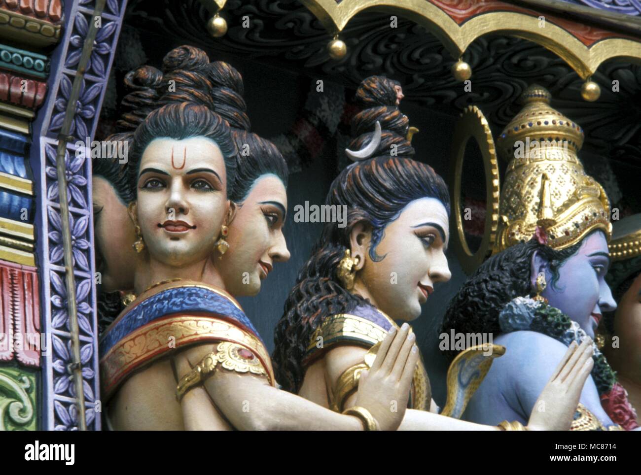 THIRD EYE - Thrd eye marking, in crescent form, on the head of a multi-headed Hindu statue on a Temple in Singapore Stock Photo