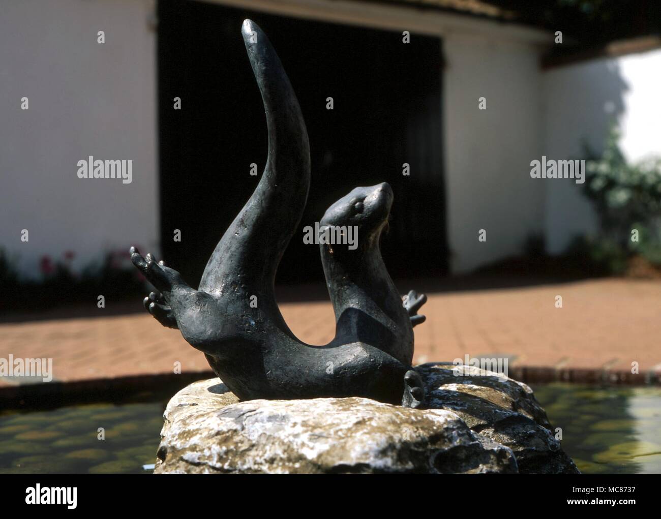 ANIMALS - Otter. Sculpture in the middle of a fountain in the courtyard