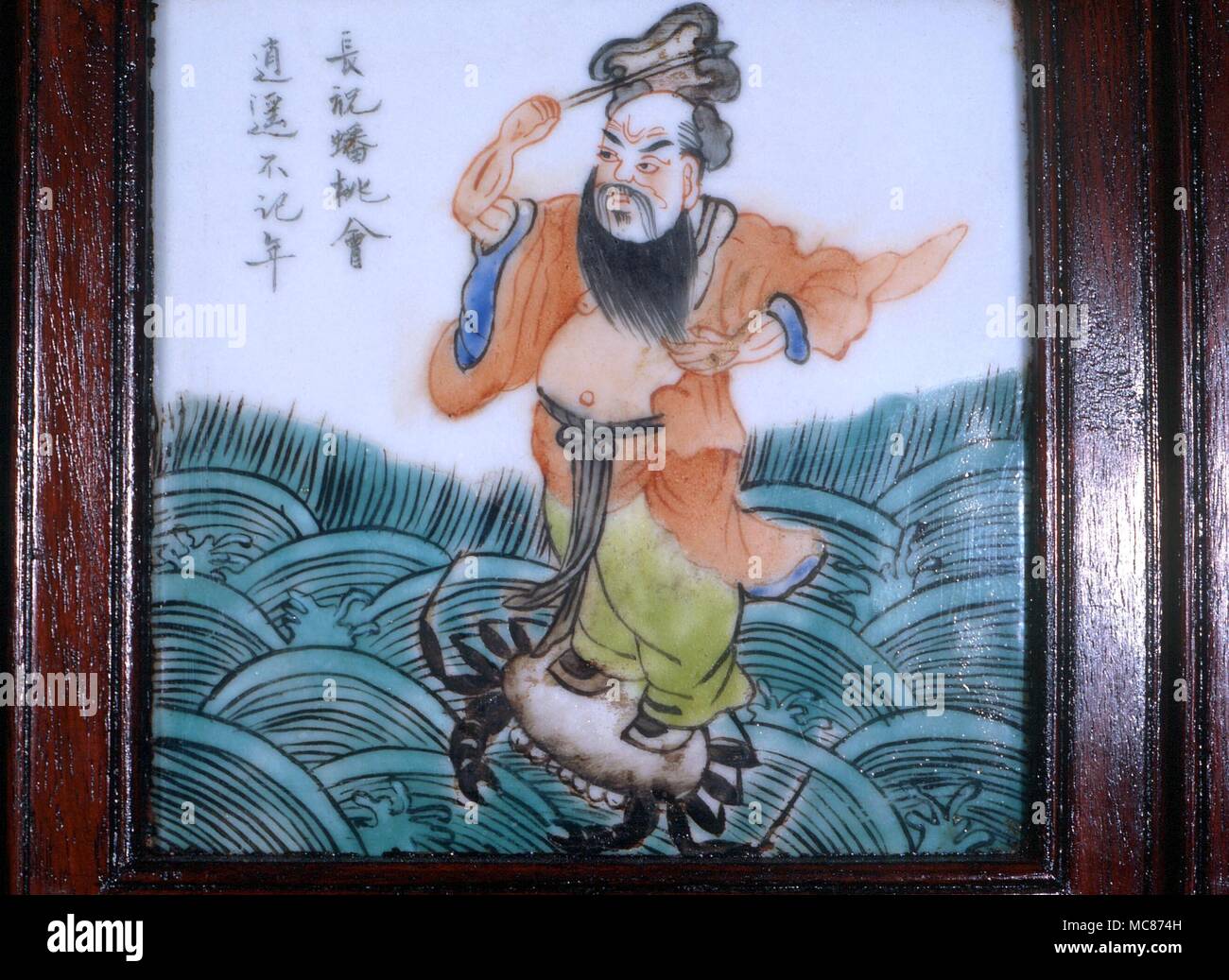 Taoism - One of the Taoist 'Eight Immortals- (Pa Hsien). Chung-li Ch'uan, who discovered the alchemical elixir of life, with his emblem, the fan. Mid-19th century Chinese tile, from a screen Stock Photo