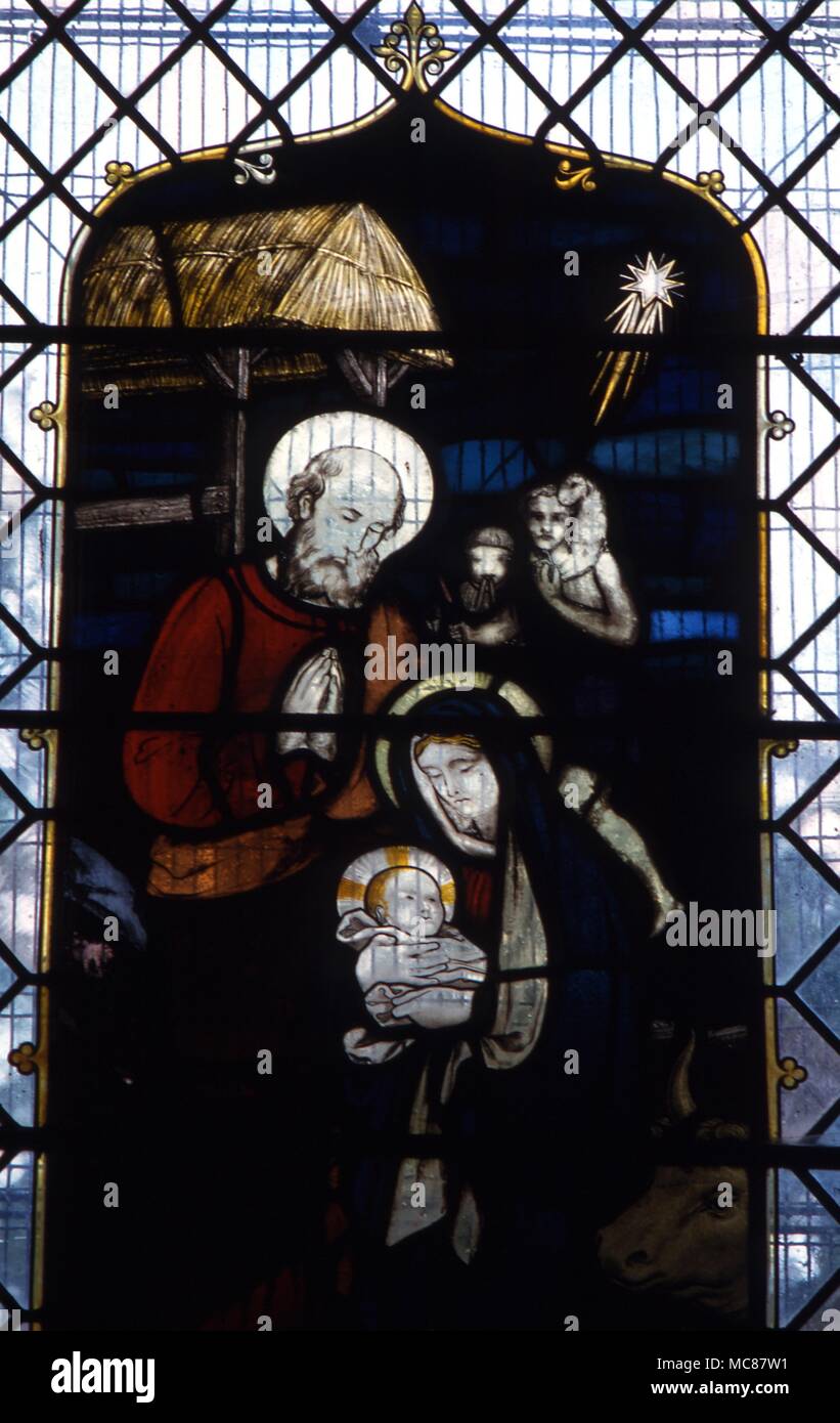 Christian Star of Bethlehem Mary Joseph and Child with the star in the heavens. 19th century stained glass in Chaldon church Surrey Stock Photo