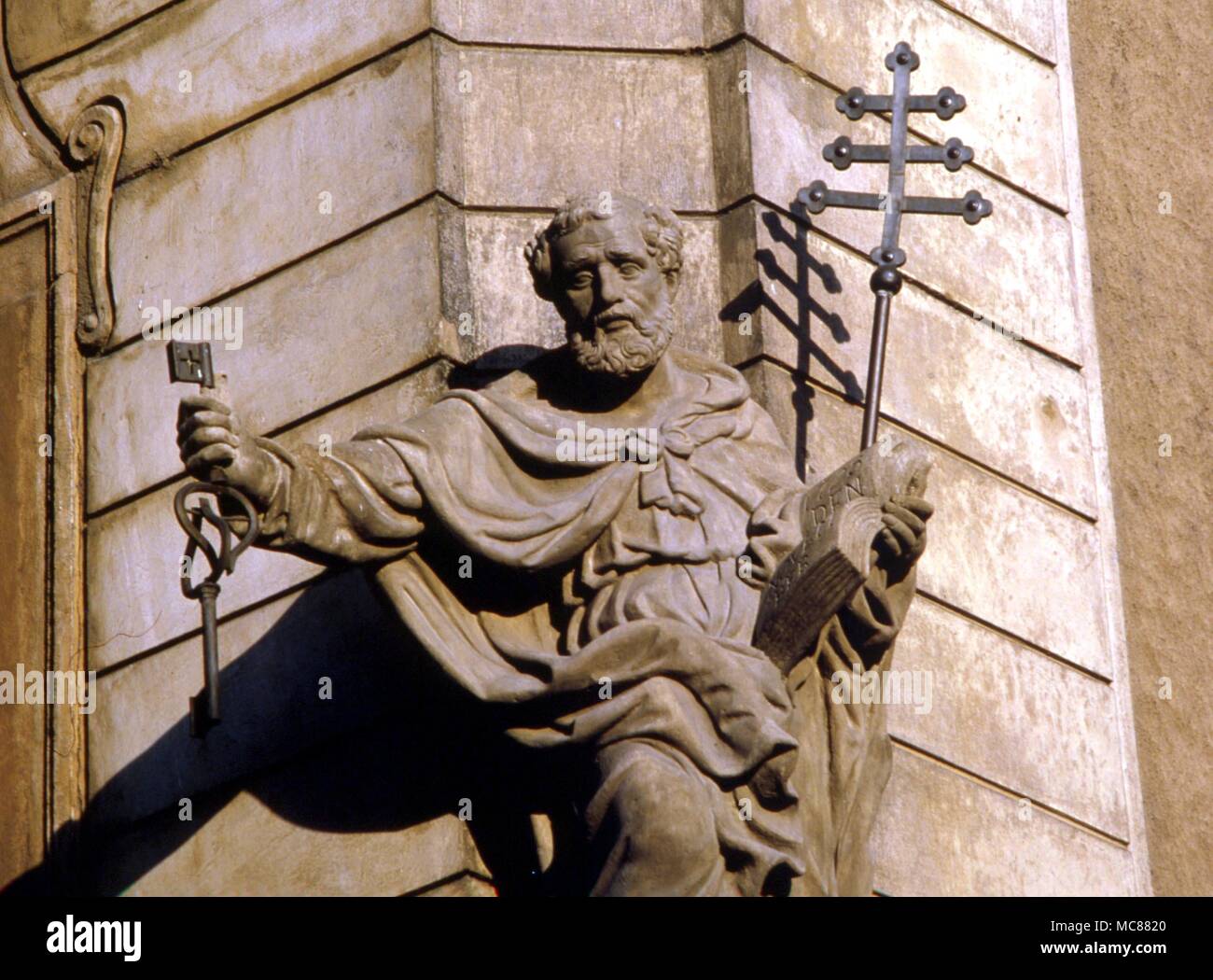 SAINTS - ST PETER - statue with triple cross and the sacred keys. On the corner of a house below the western end of the Charles Bridge in Prague Stock Photo