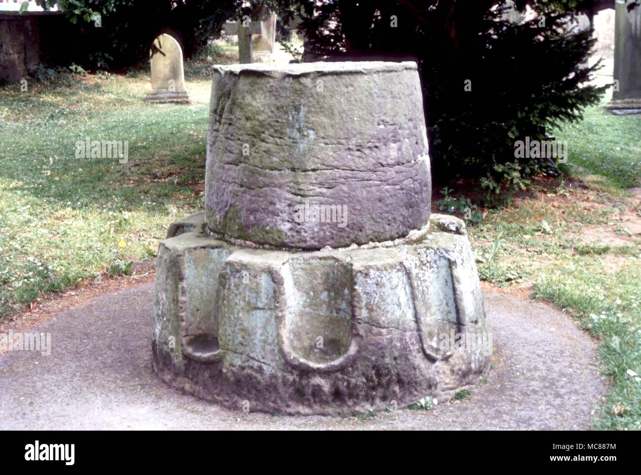 CHRISTIAN The kneeling cross (of which only the base remains) in the churchyard at Ripley Stock Photo
