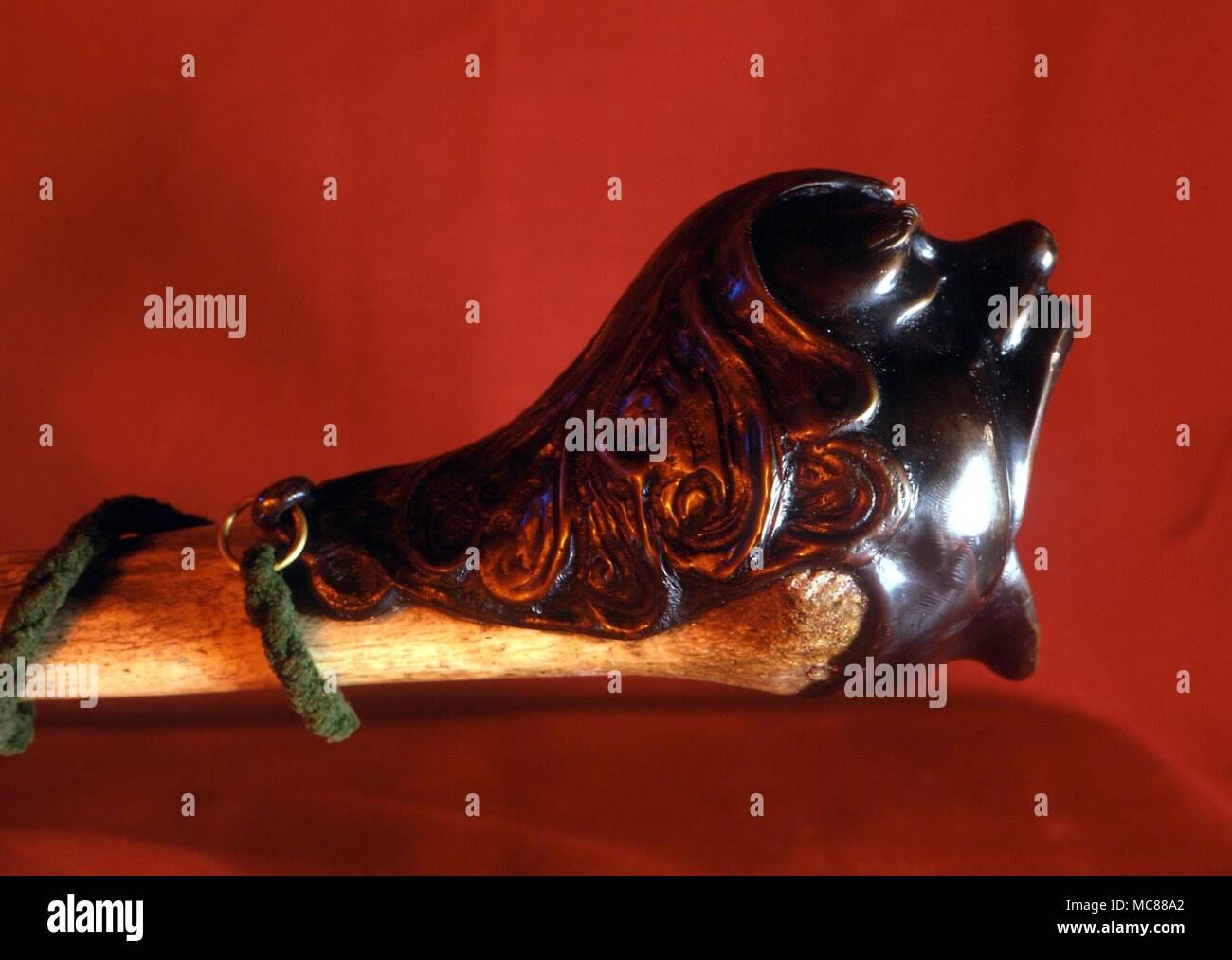 WITCHCRAFT Shamansitic trumpet used in witchcraft rites - bronze demonic head mounted on a human thigh bone Stock Photo