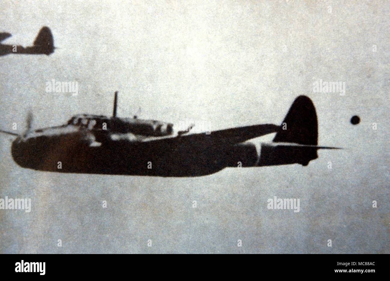 UFO - unidentified flying object Photographed over the Japanese sea in 1943. The plane is a Sally Bomber Stock Photo
