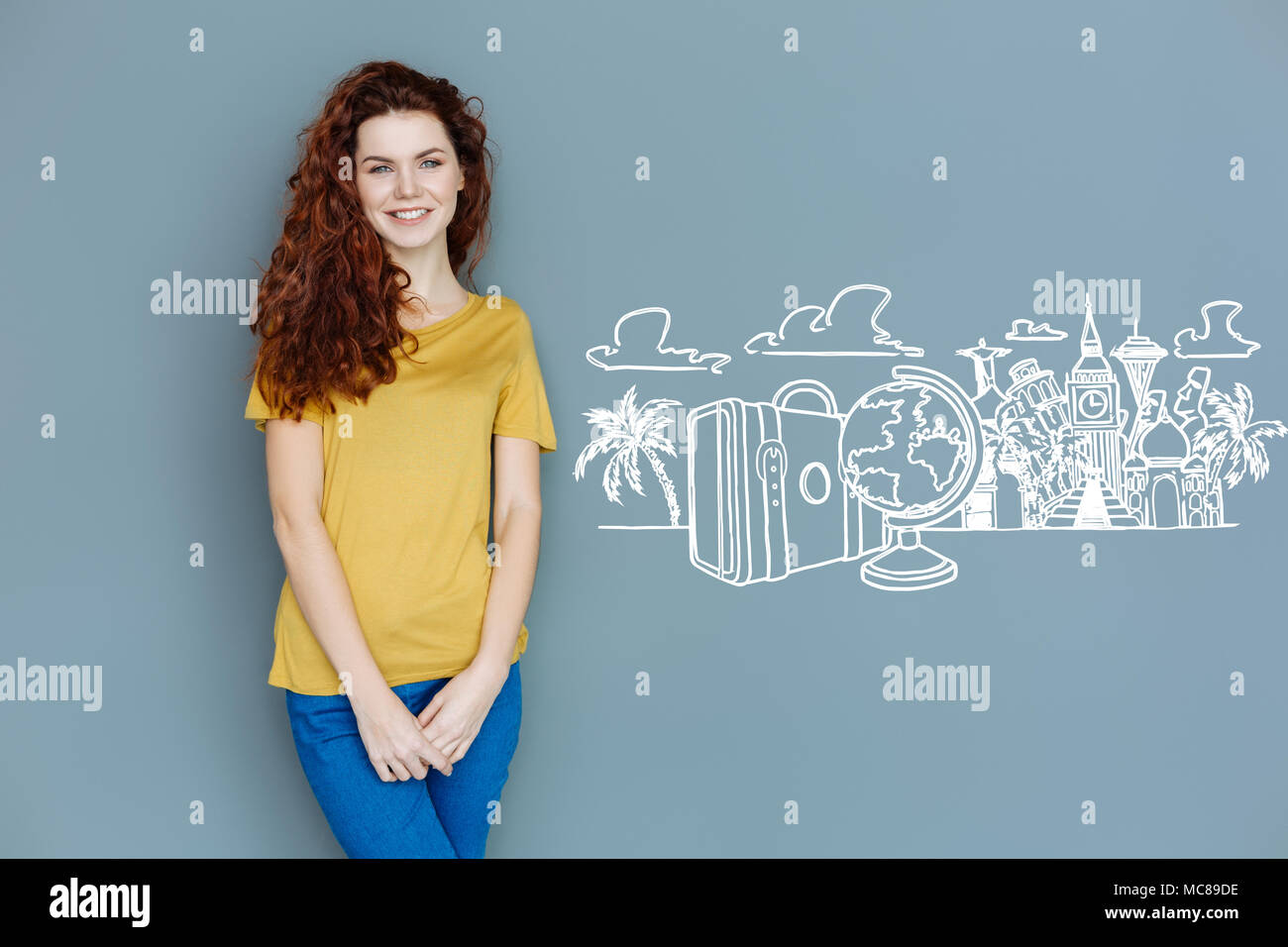 Smiling student waiting for travelling abroad and smiling Stock Photo