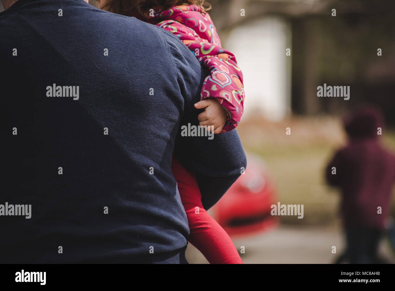 A child being held by her father Stock Photo Alamy