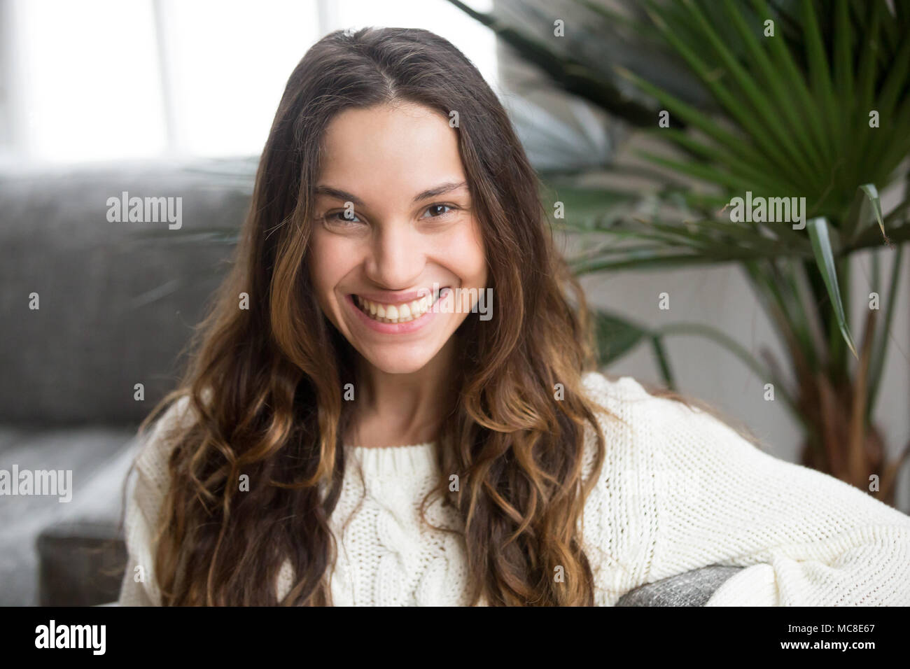 Headshot portrait of mestizo girl with white teeth and wide toothy smile, cheerful attractive young mulatto woman feeling happy looking at camera, bea Stock Photo