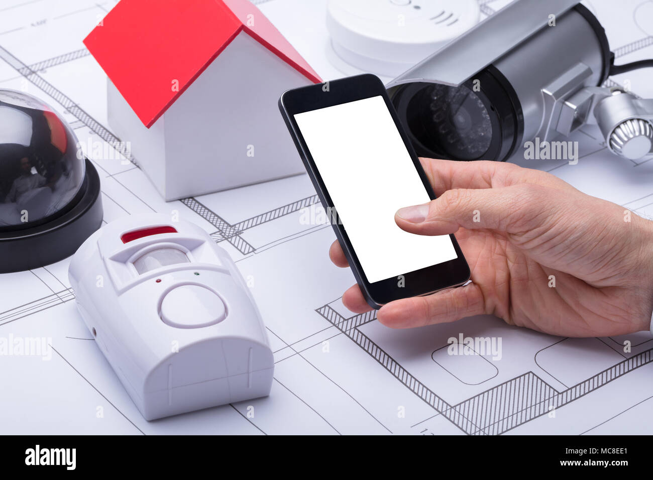 Architect's Hand Using Mobile Phone With Blank White Screen Stock Photo