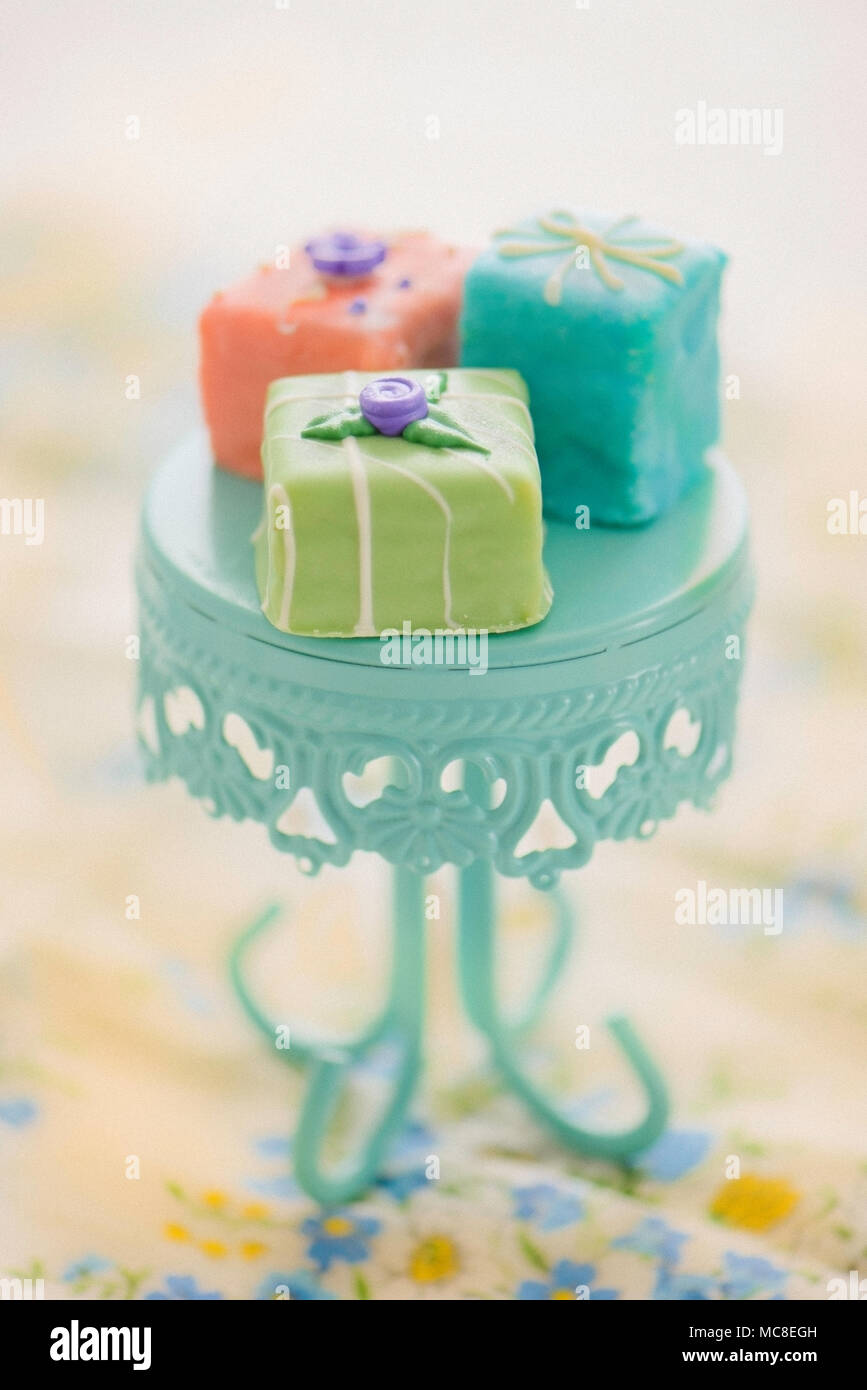 Petit fours on an aqua pedestal Stock Photo