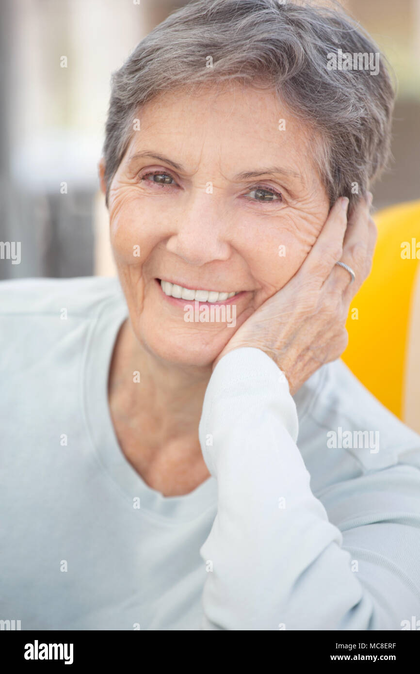 Happy mature woman with grey hair smiling Stock Photo - Alamy