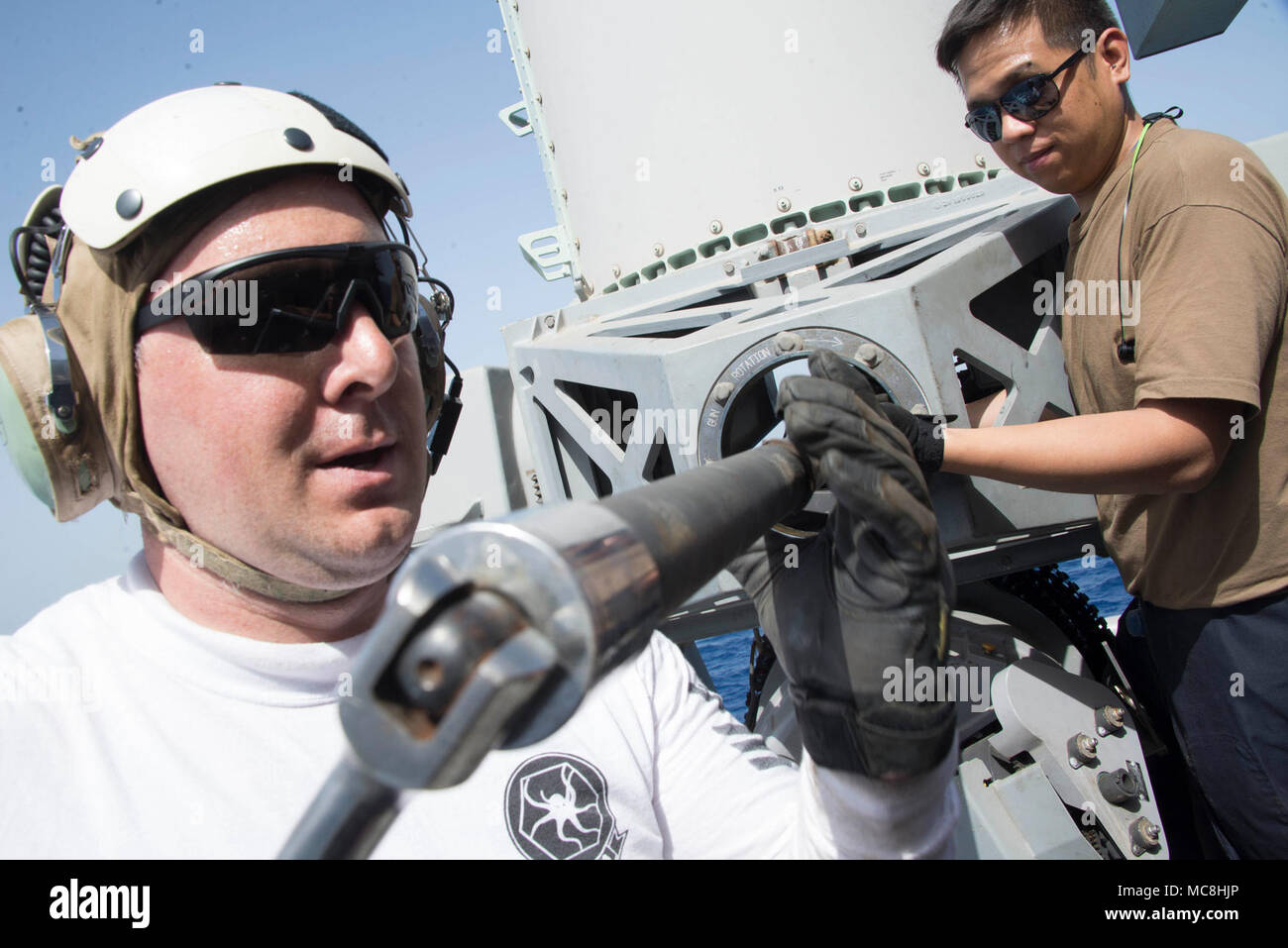 U.S. 5TH FLEET AREA OF OPERATIONS (March 26, 2018) Aviation Machinist Mate 1st Class Aaron Williams and Fire Controlman 2nd Class Michael Floresca remove a barrel from a close-in weapons system (CIWS) aboard the Wasp-class amphibious assault ship USS Iwo Jima (LHD 7), March 26, 2018. Iwo Jima, homeported in Mayport, Fla., is on a regularly scheduled deployment to the U.S. 5th Fleet area of operations in support of maritime security operations to reassure allies and partners, and preserve the freedom of navigation and the free flow of commerce in the region. Stock Photo